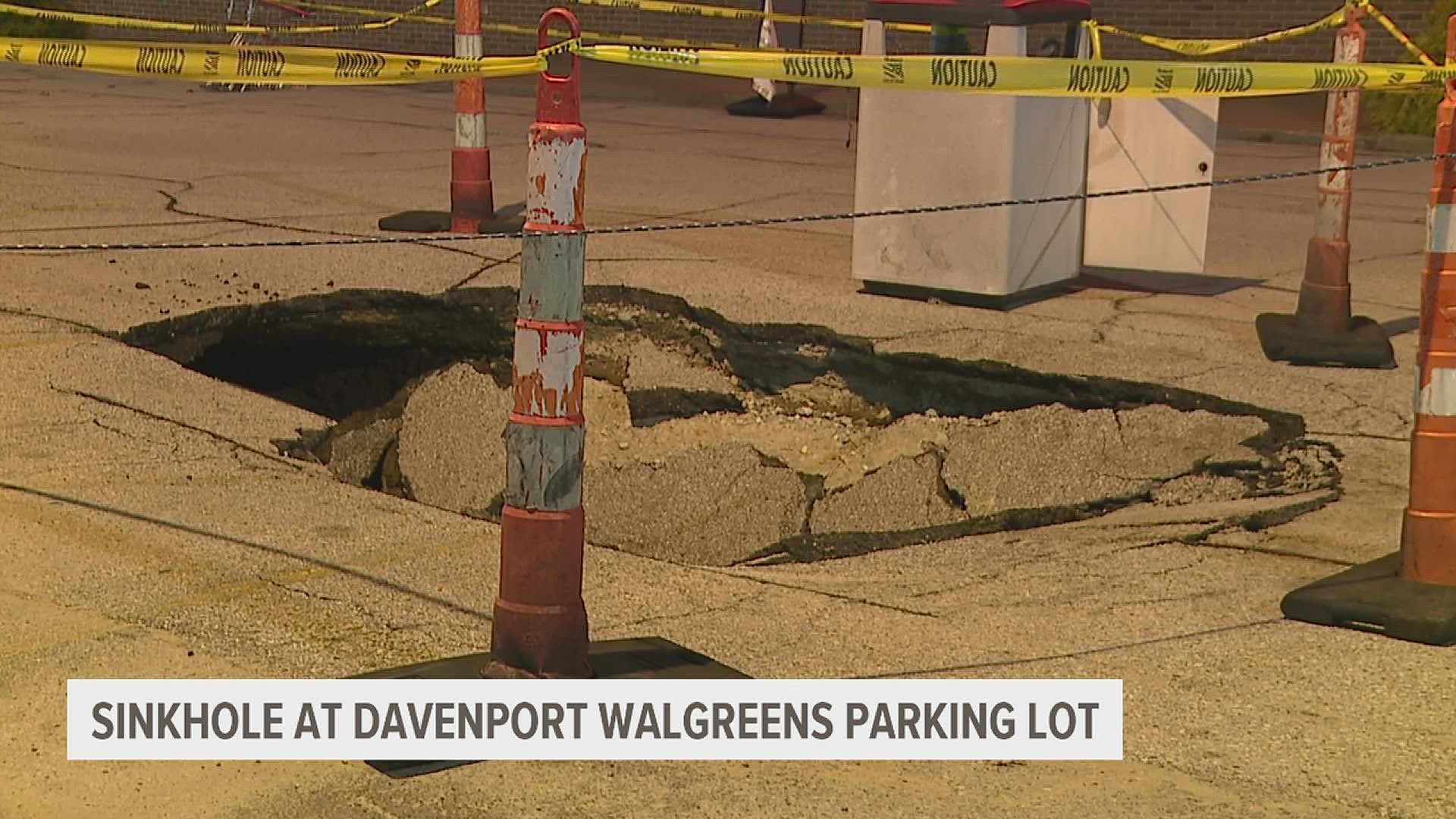 Part of the parking lot of the Davenport Walgreens on Kimberly Road and Eastern Avenue has caved in, though the business is still open.