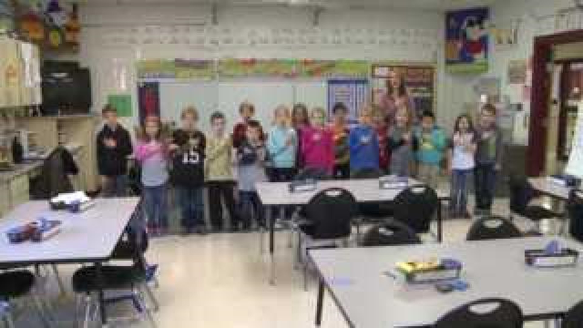 Mrs. Lueders' class says the Pledge of Allegiance