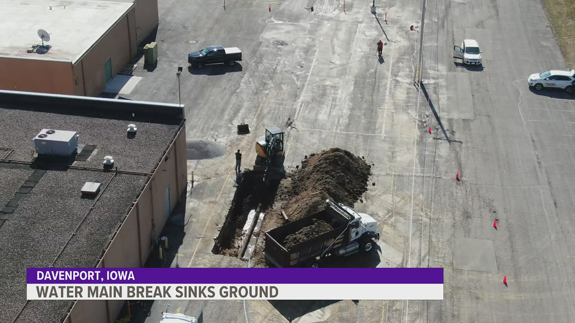 A water main break caused the asphalt to weaken and collapse behind the Village Shopping Center in Davenport. One car drove into the sinkhole.