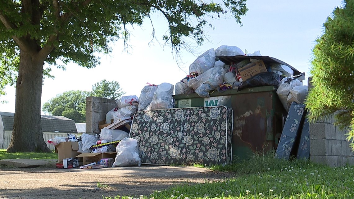 Monthold trash build up outside two apartments in Wataga, Illinois enrages tenants