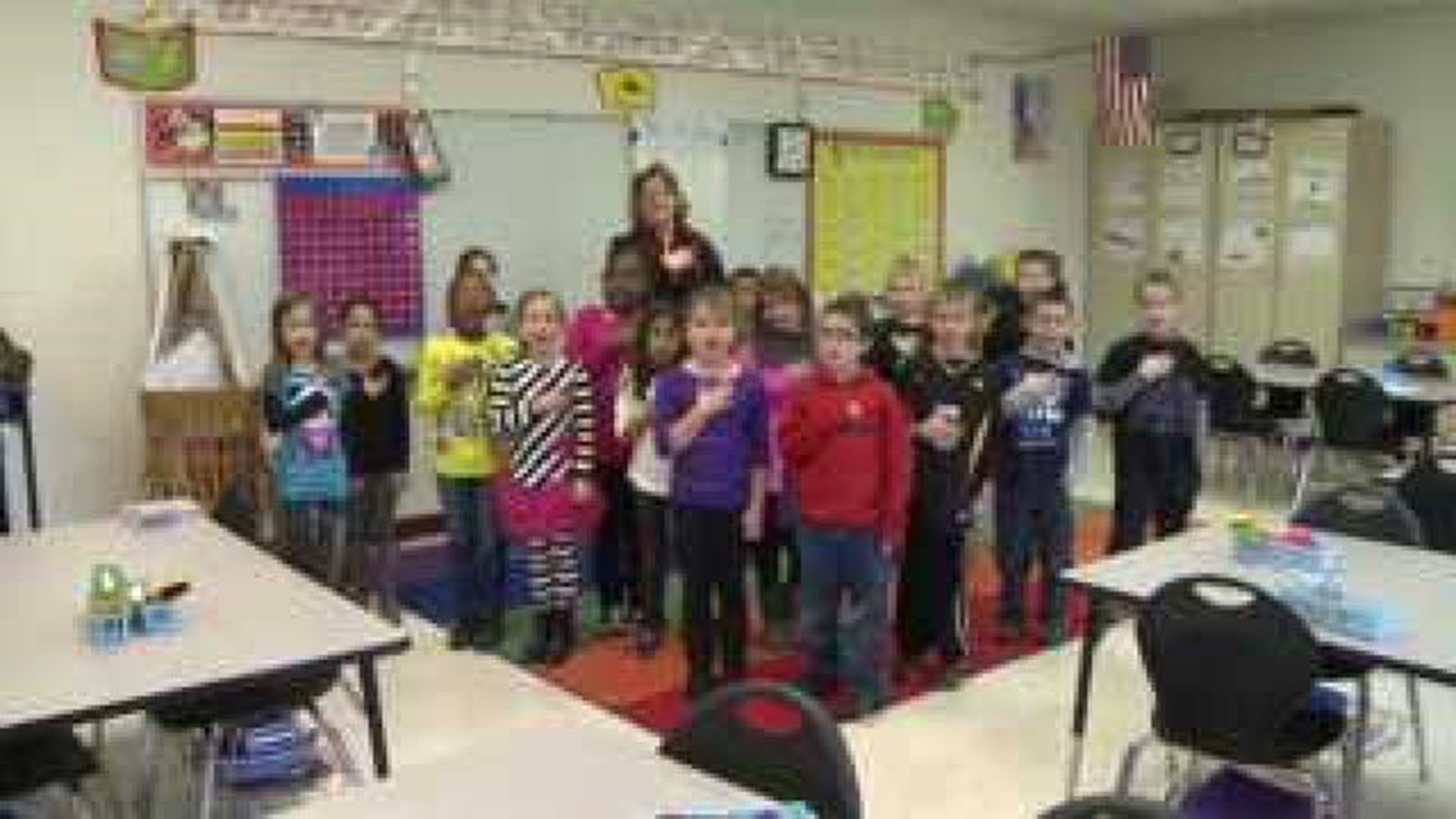 Mrs. Dolan's class says the Pledge of Allegiance