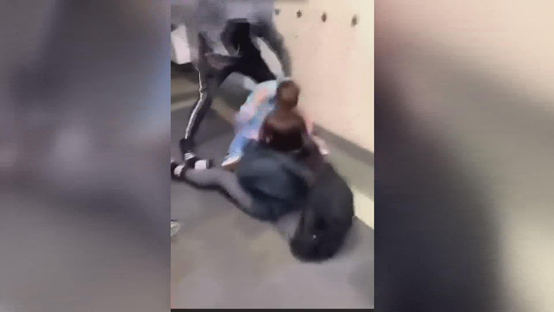 The video shows the 15 year old student being yanked backwards to the ground