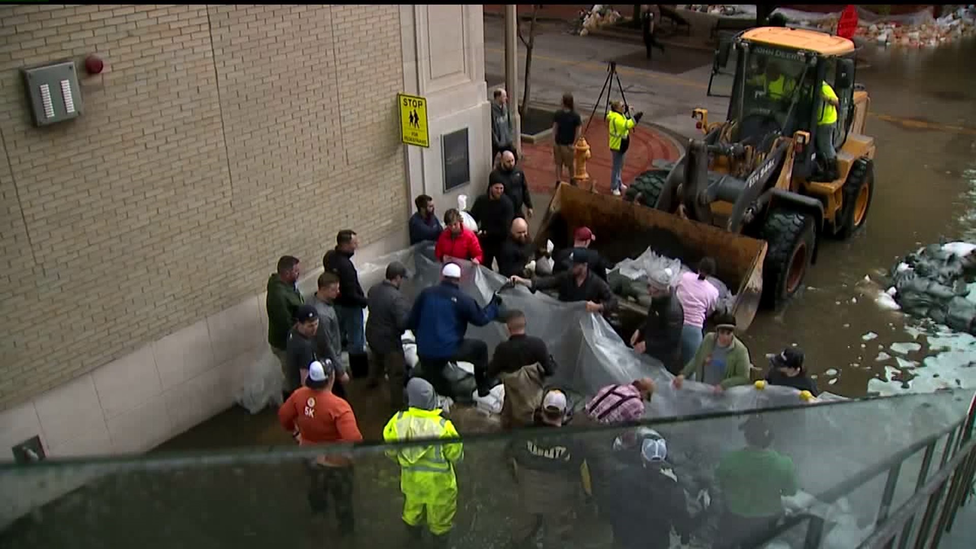 Volunteers help build sandbag walls in downtown Davenport