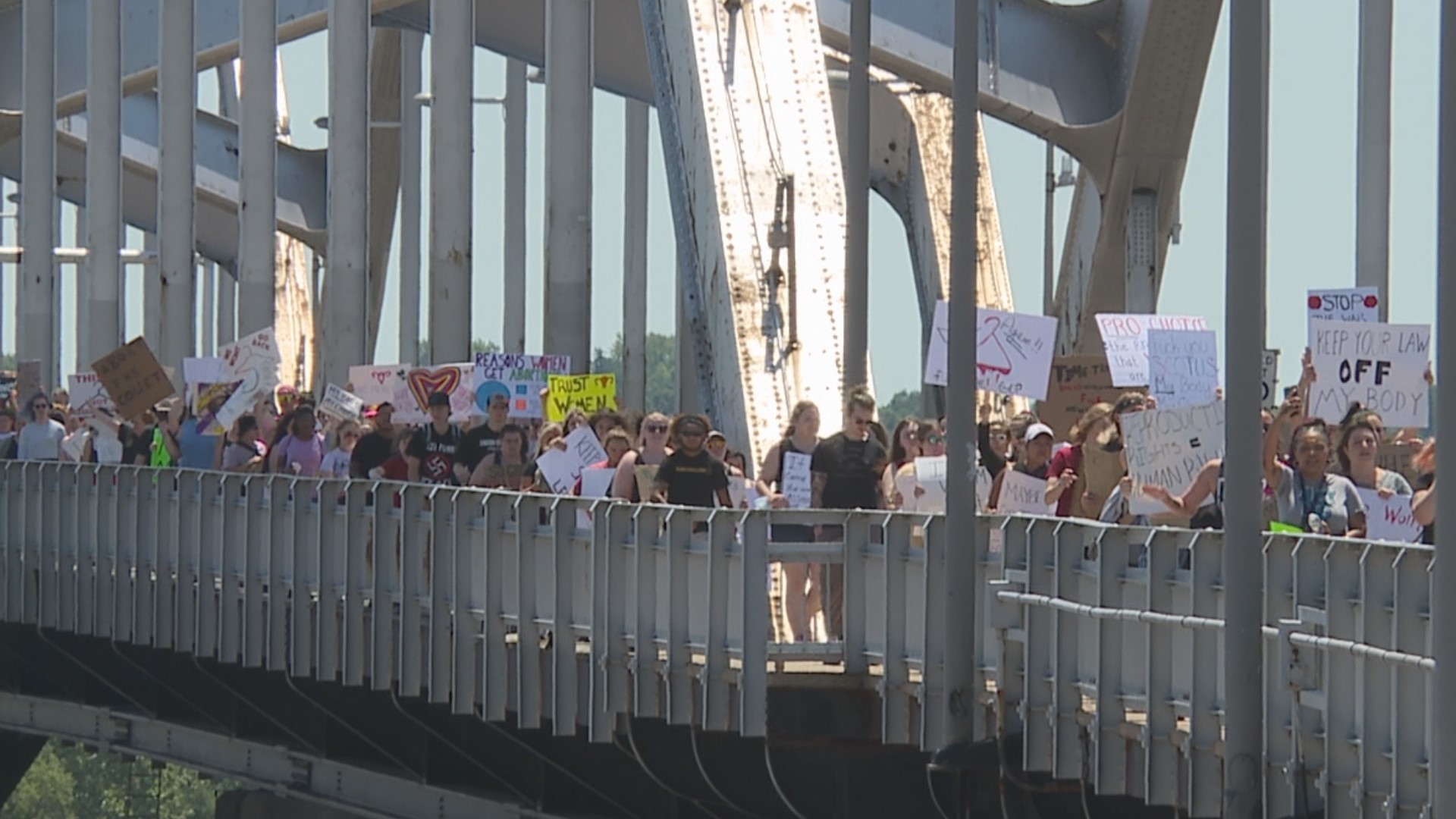 A large group of abortion rights protesters marched on Monday from Schwiebert Park and across the Centennial Bridge into Davenport.