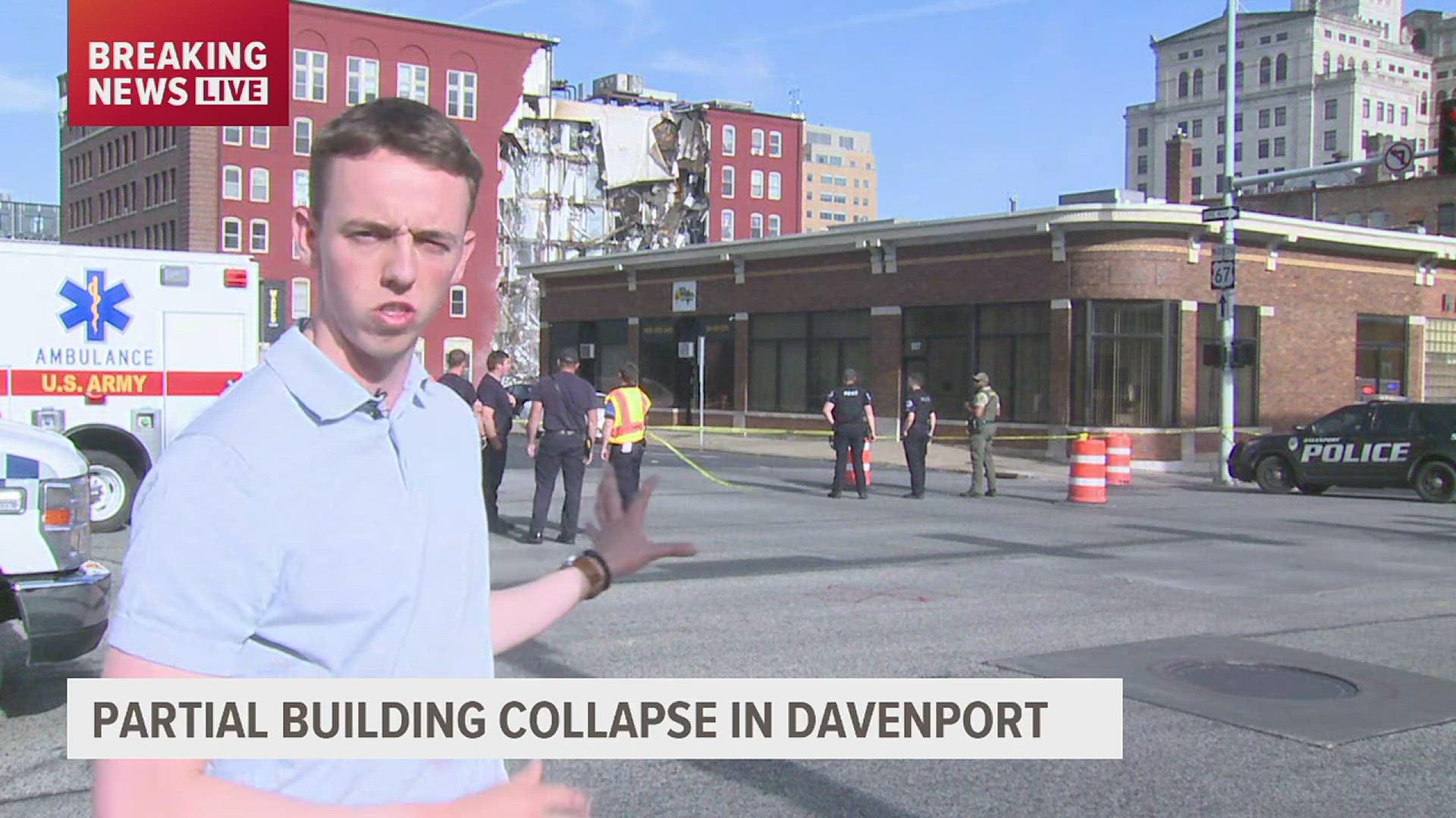 An entire side of the apartment building has collapsed, with at least six stories exposed.