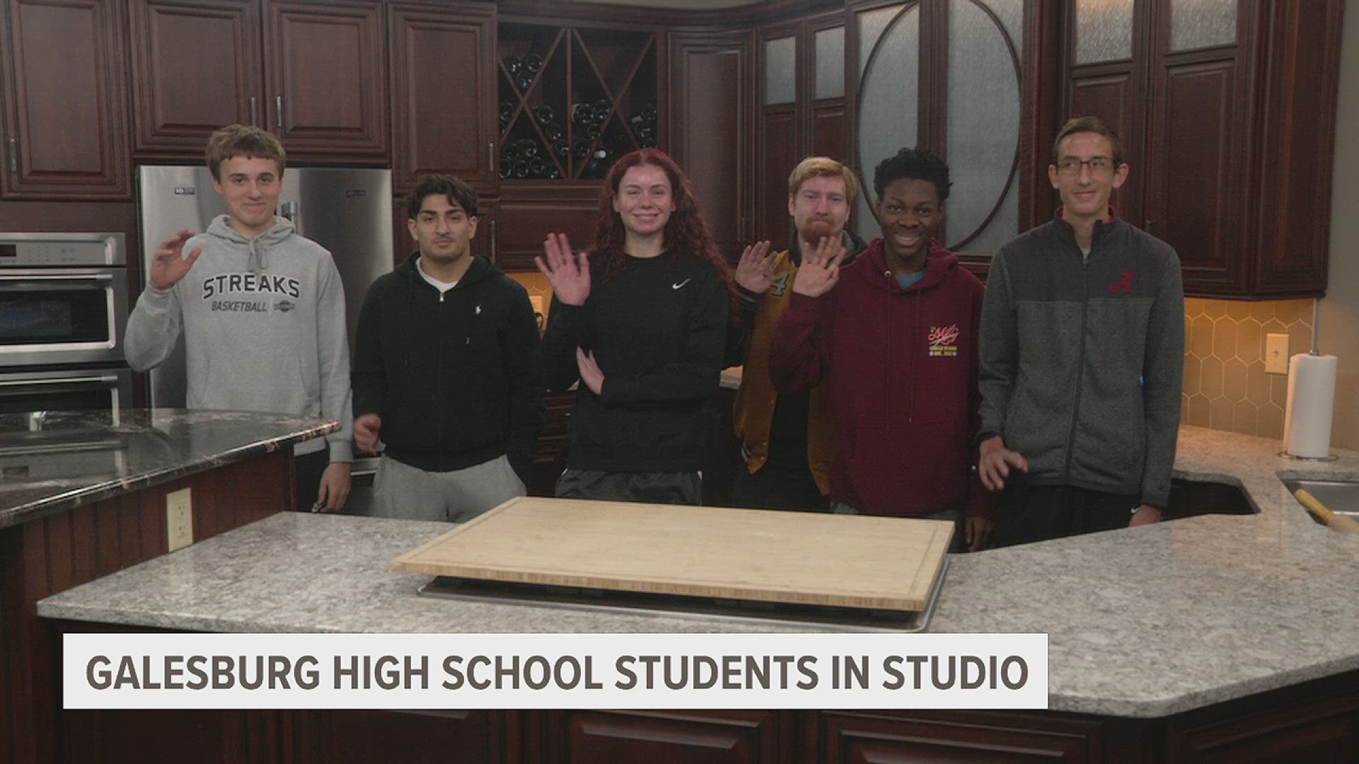 The group of students is part of a 'Media Writing and Broadcasting' class and came to see the behind-the-scenes work at a television station.
