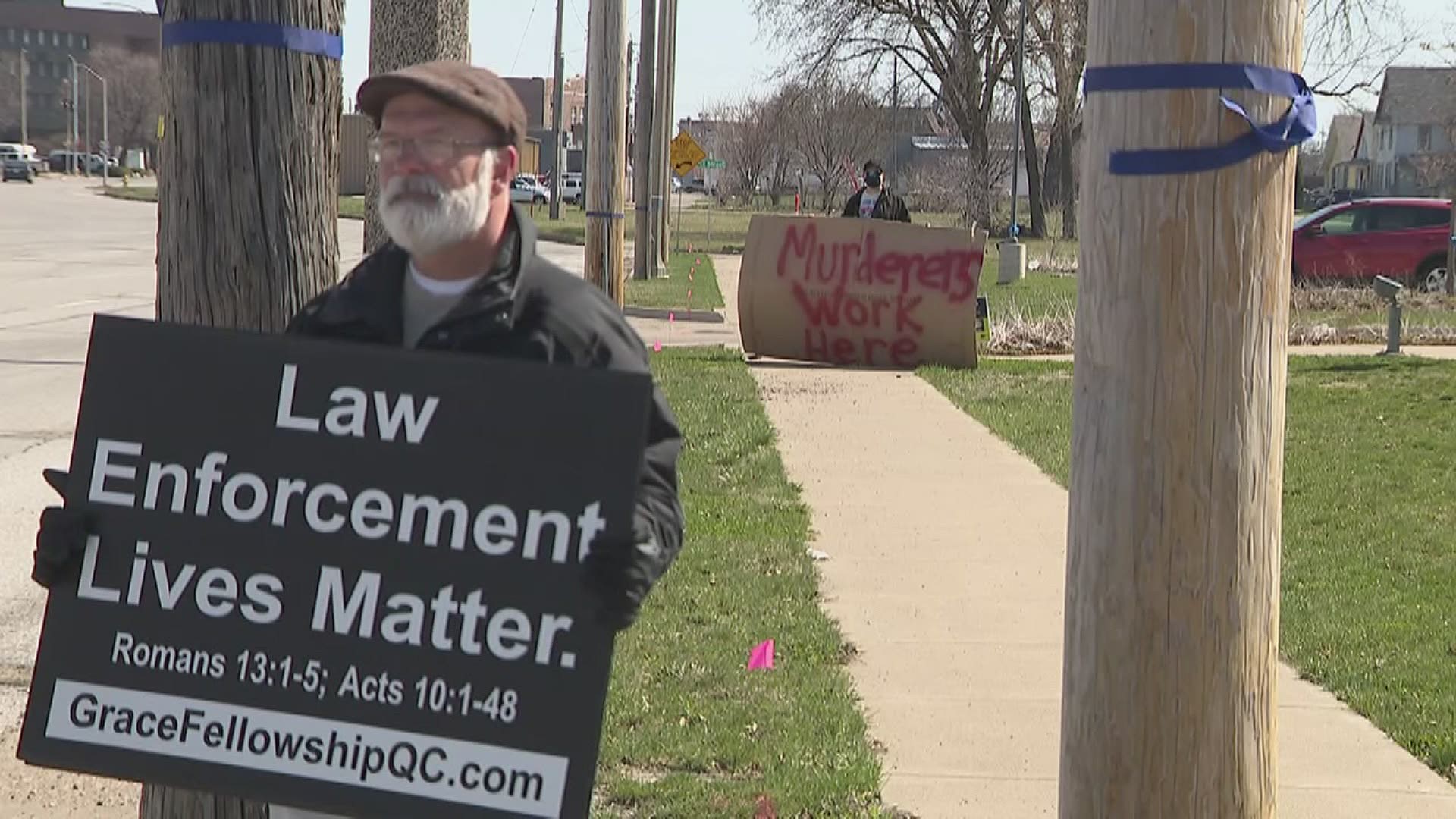 An officer involved shooting on April 1 left one man dead. The next day, two lone protesters met outside of the Rock Island Police Department with opposing messages.