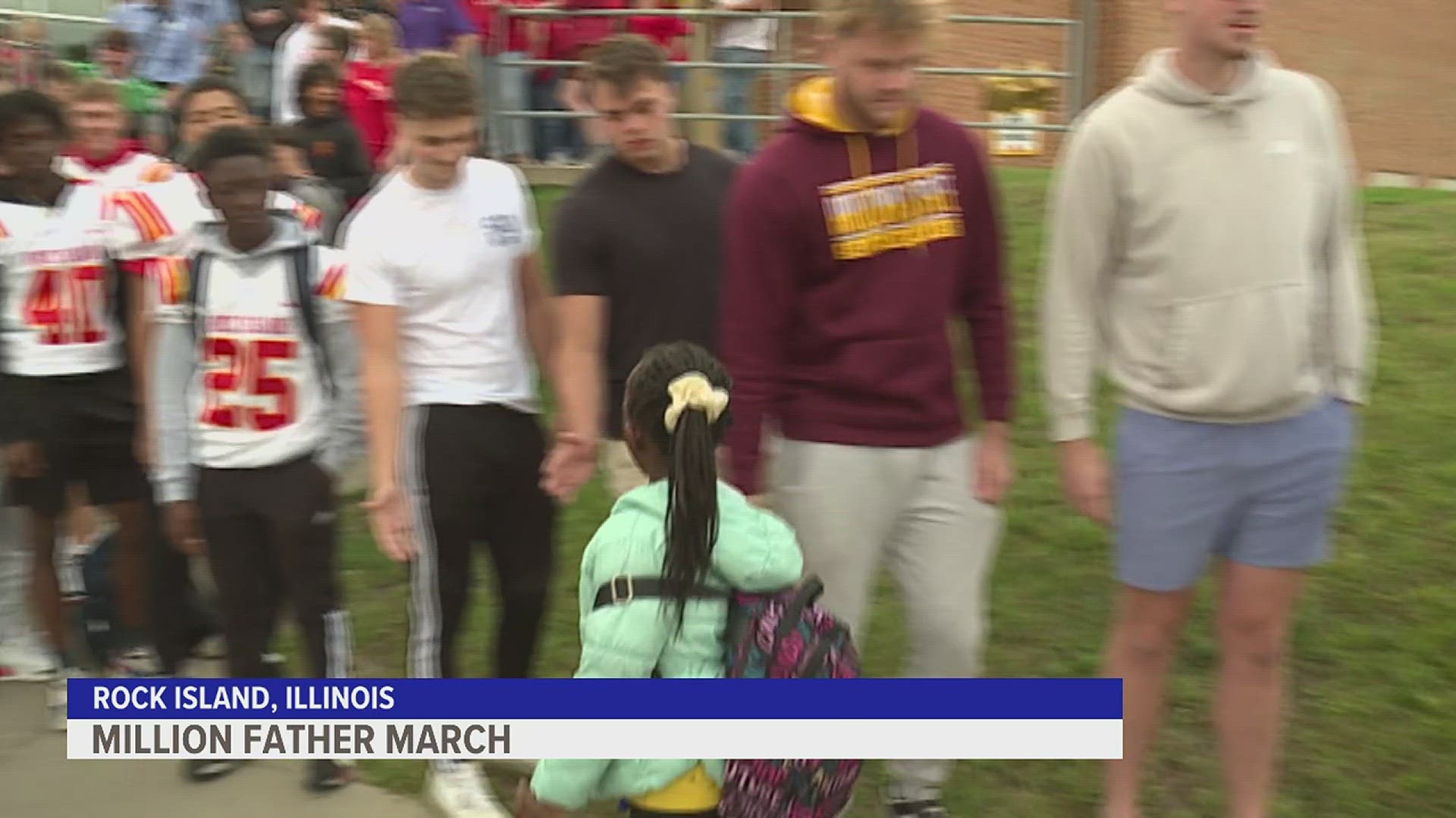 Men from the community lined up to give cheers and high-fives to students as they came to school.