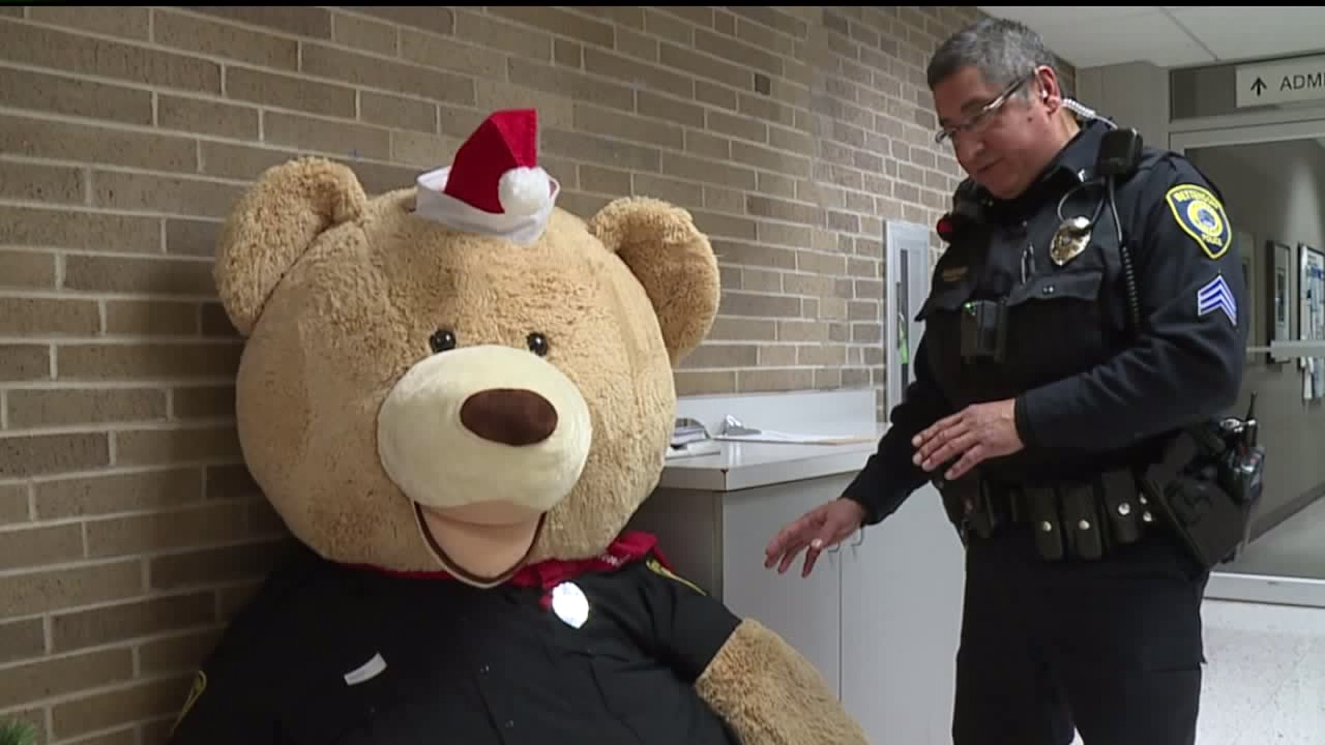 Honorary Bettendorf Police Officer gets help suiting up