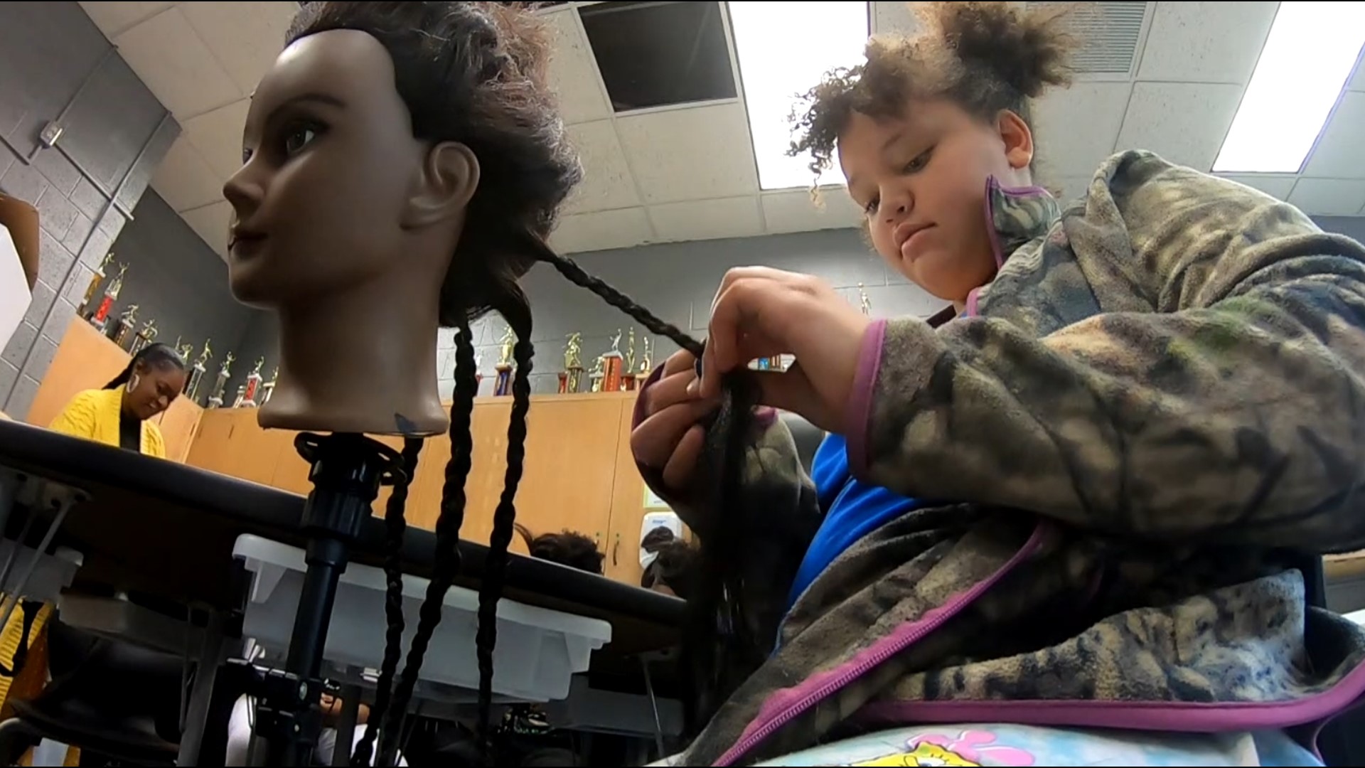 Step inside this after-school club and you'll see students practicing box braids, knotless and everything in between as they weave together skill and creativity.