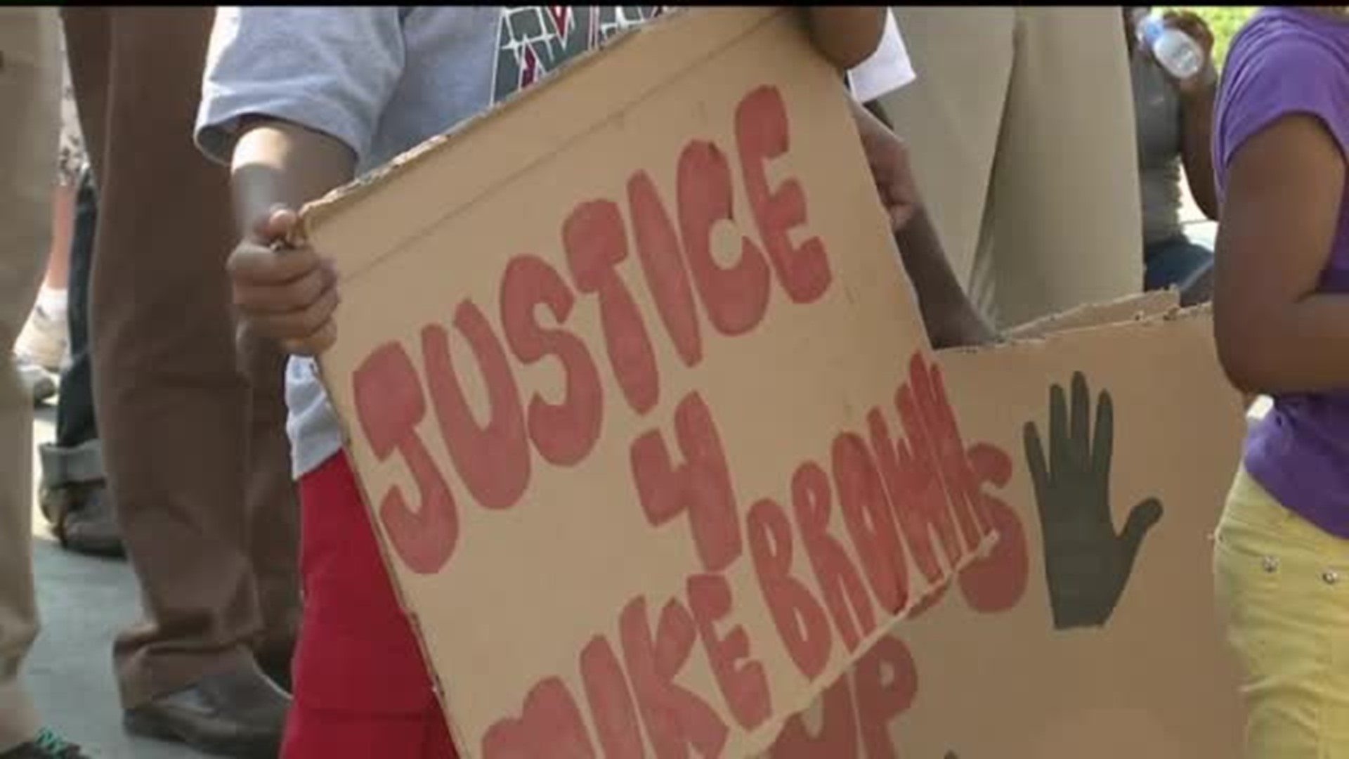 Dozens march through Rock Island for justice for Michael Brown