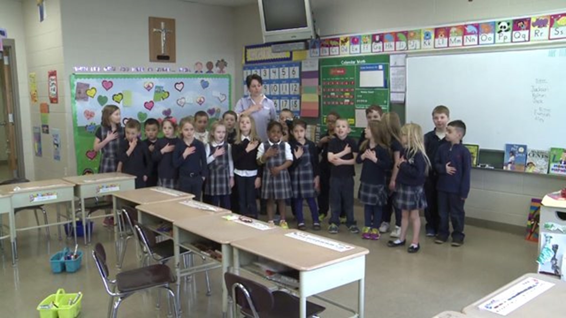 Mrs. Schmall`s class says the Pledge of Allegiance