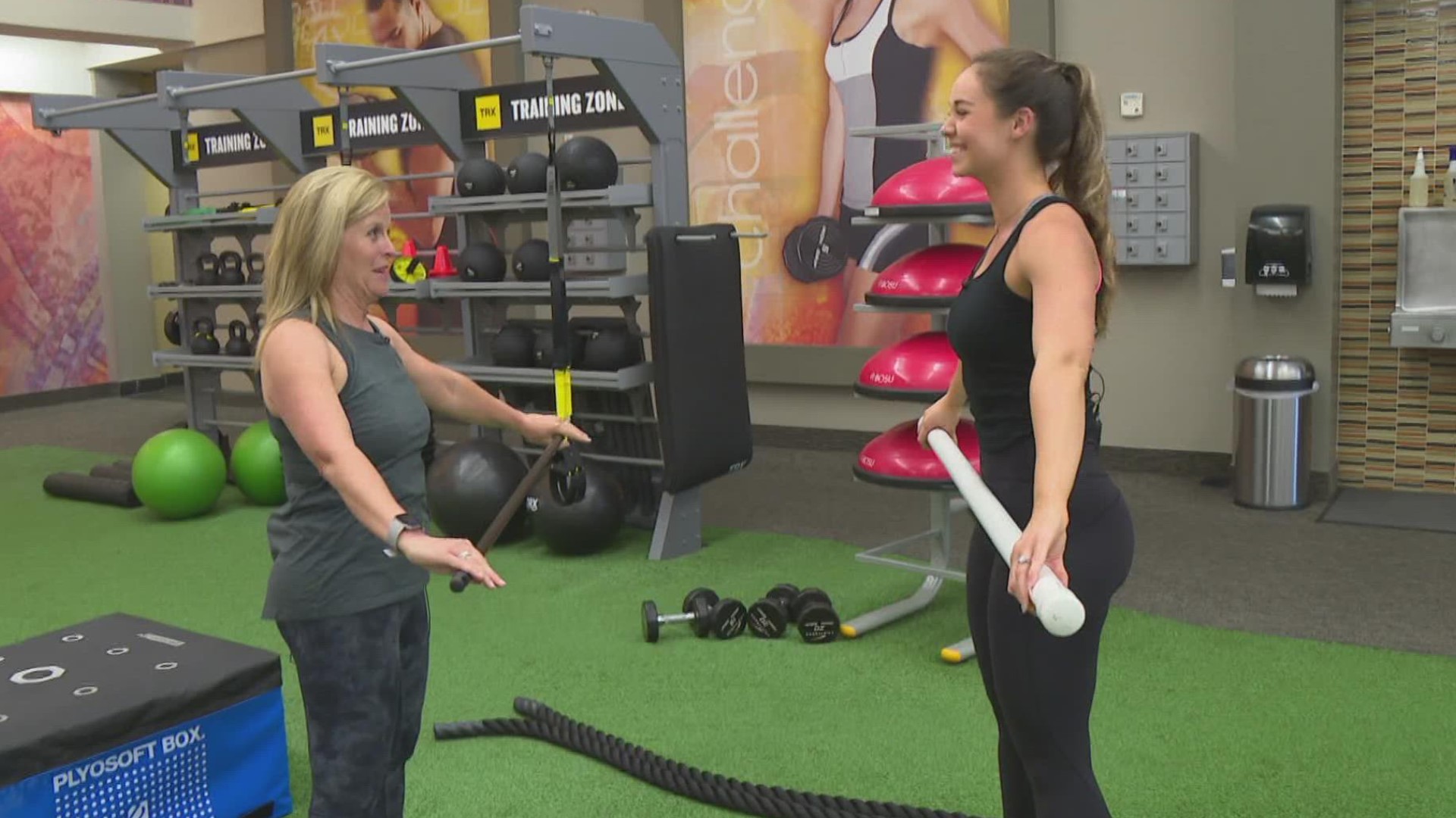 Trainer Lydia Horner at LA Fitness demonstrates the stick mobility challenge.