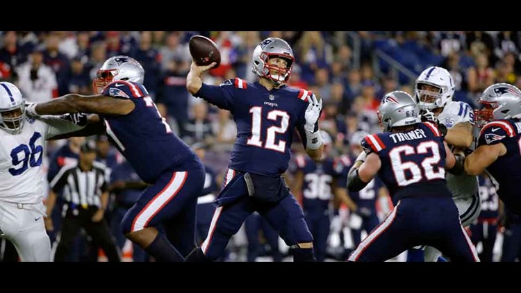 New England Patriots quarterback Tom Brady (12) is pressured by