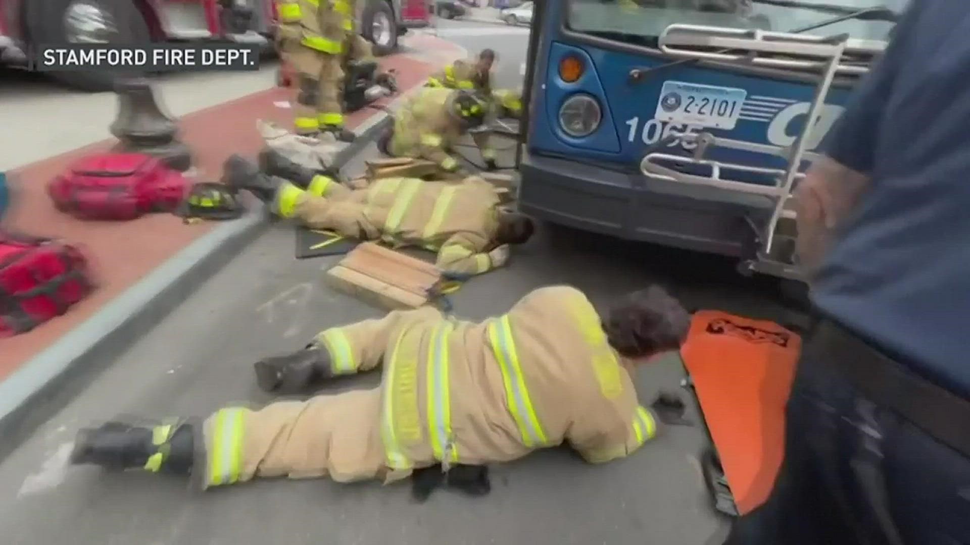 Firefighters rescued a woman who was hit by a city bus in Connecticut on Tuesday, July 5 and trapped beneath it.