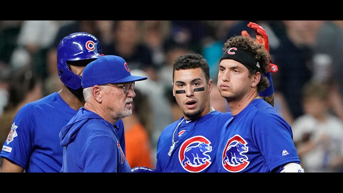 Chicago Cubs' Albert Almora Jr., center, is comforted by a