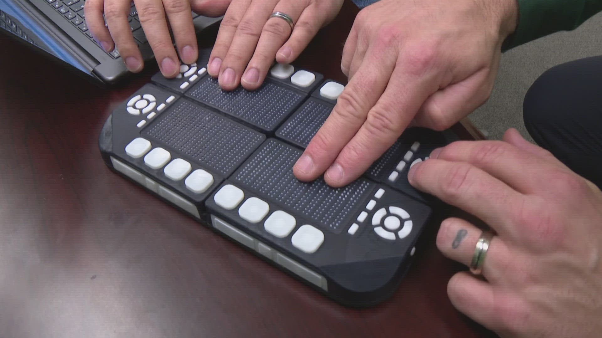 13News reporter and anchor Dustin Grove talks with Wunji Lau and his co-founder at Tactile Engineering on their new invention helping the blind see the eclipse.