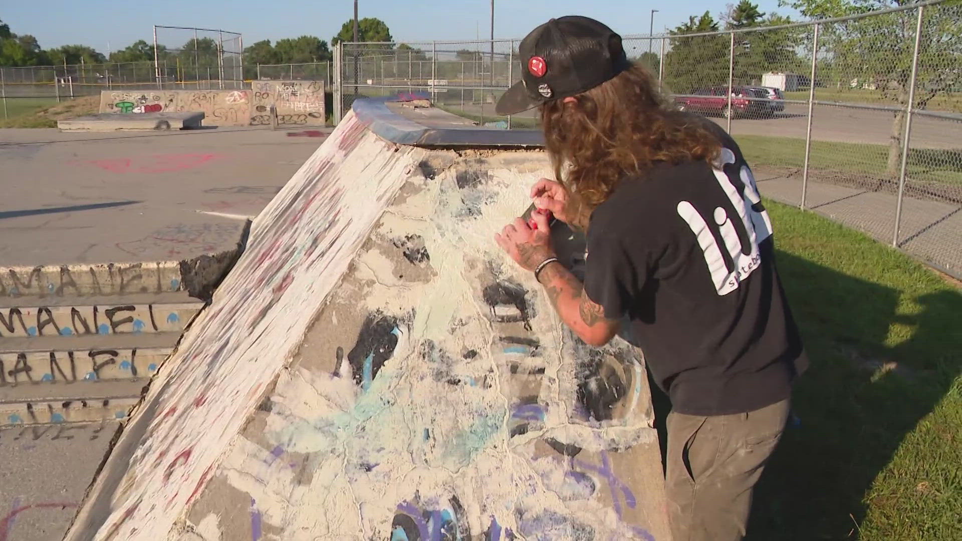 Artists and skaters come together to clean up the Lawrence skate park.