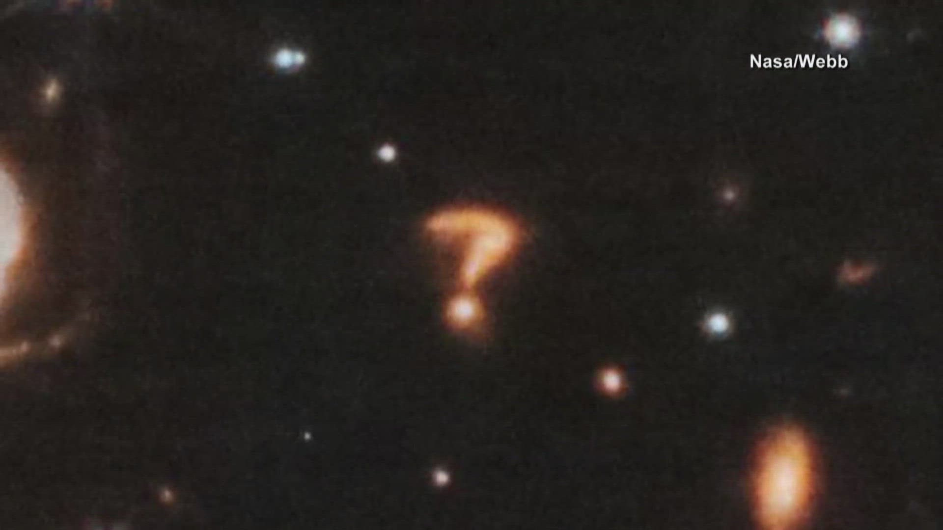 Check out this cosmic phenomenon caught on the James Webb Telescope. It's a blob of light seemingly in the shape of a question mark.