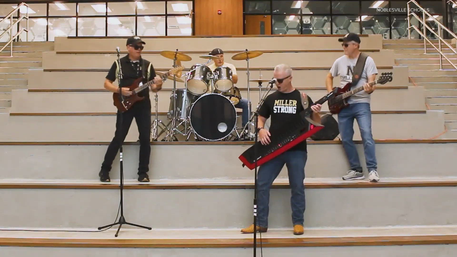 The song video features the superintendent of schools at the microphone.
