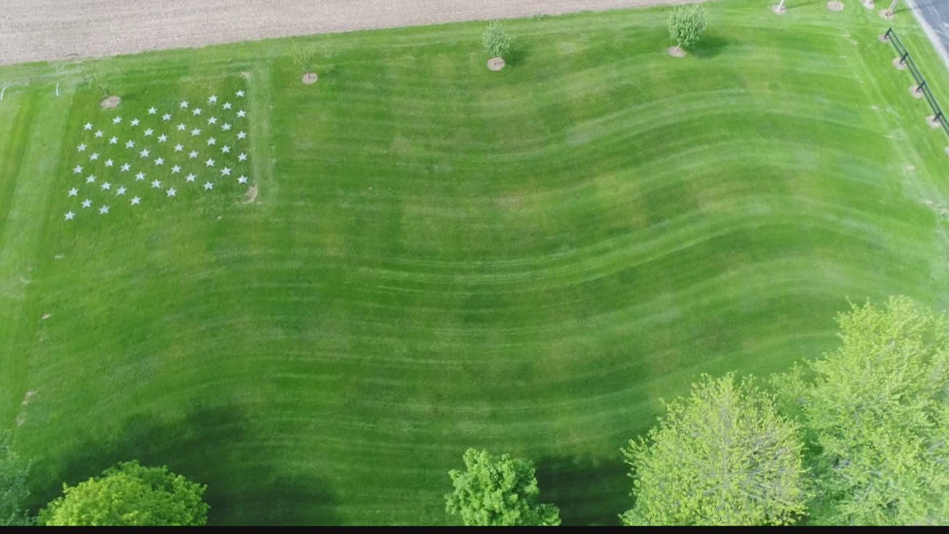 Rob Merchant created a giant flag in his front lawn to honor one his former middle school wrestlers, who was killed in Afghanistan in 2011.