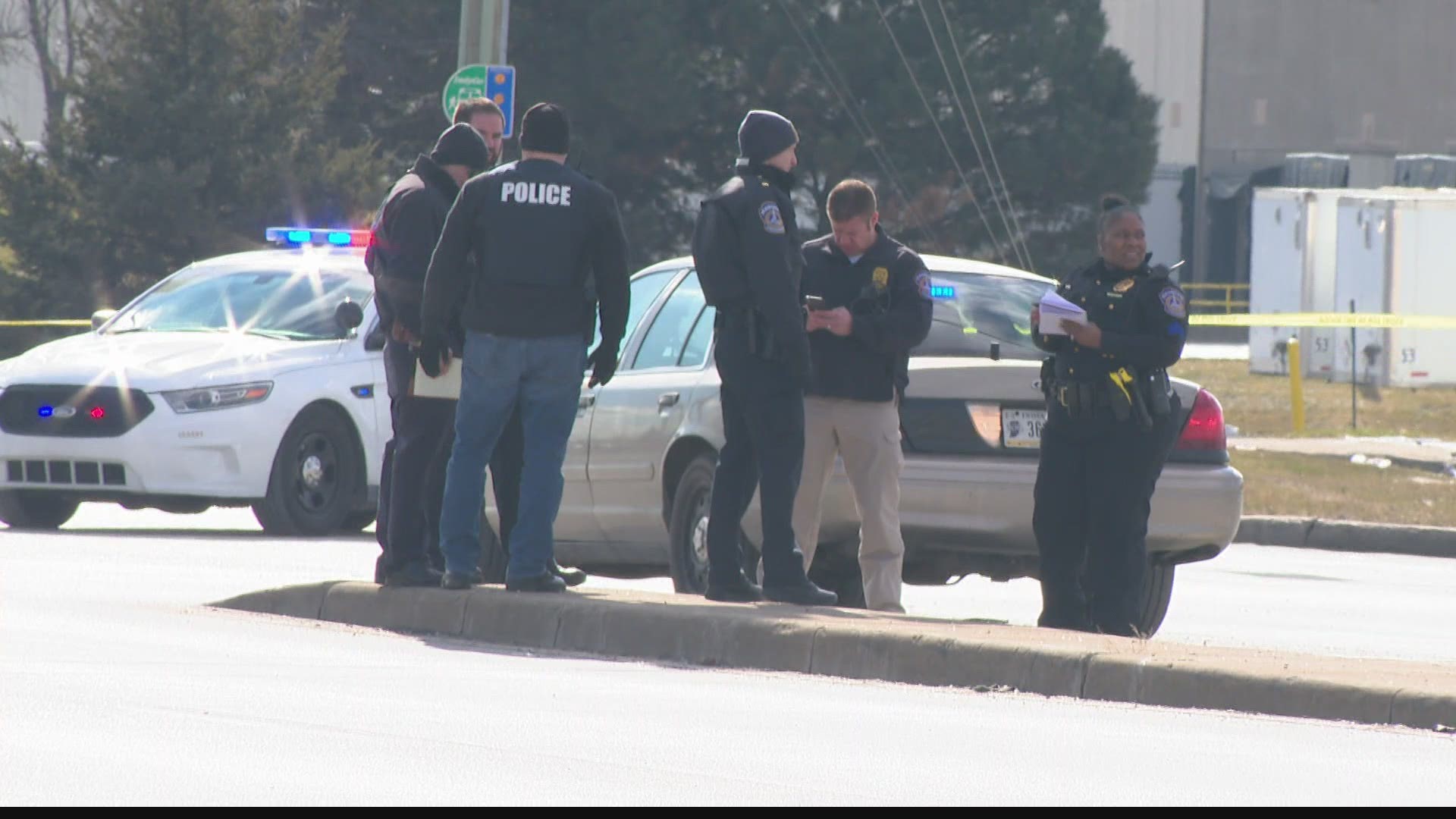 Two people were injured after what police described as a shoot out at a busy intersection.