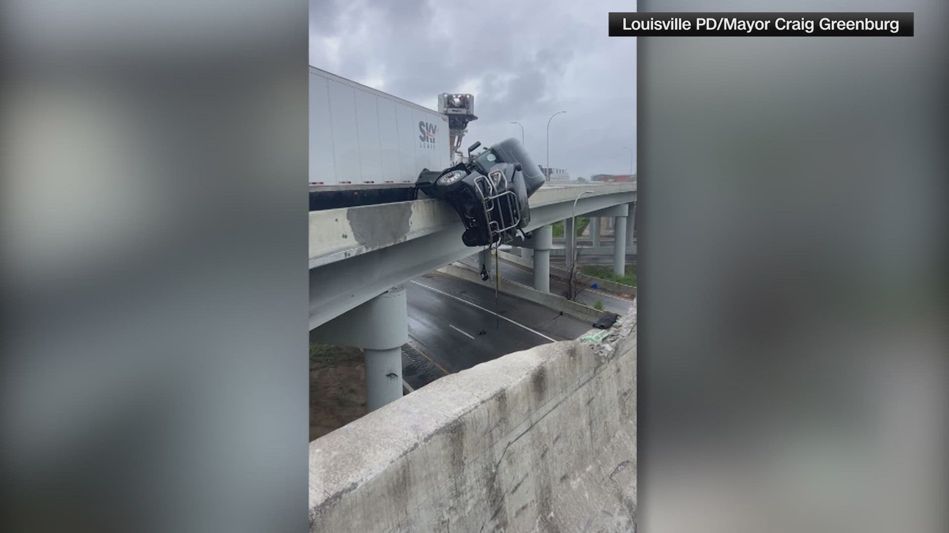 Semi driver rescued after crash causes truck to dangle off Kennedy ...