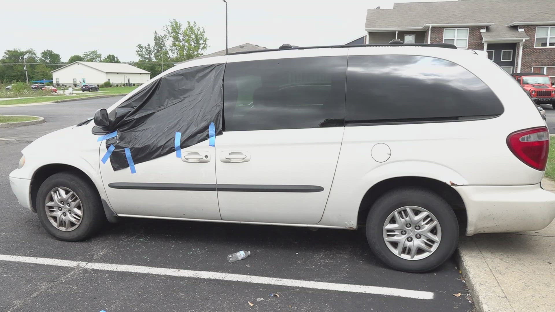 The driver's seat of Desiree Woodson's van is now stained with blood, while pieces of glass cover her floor mat.