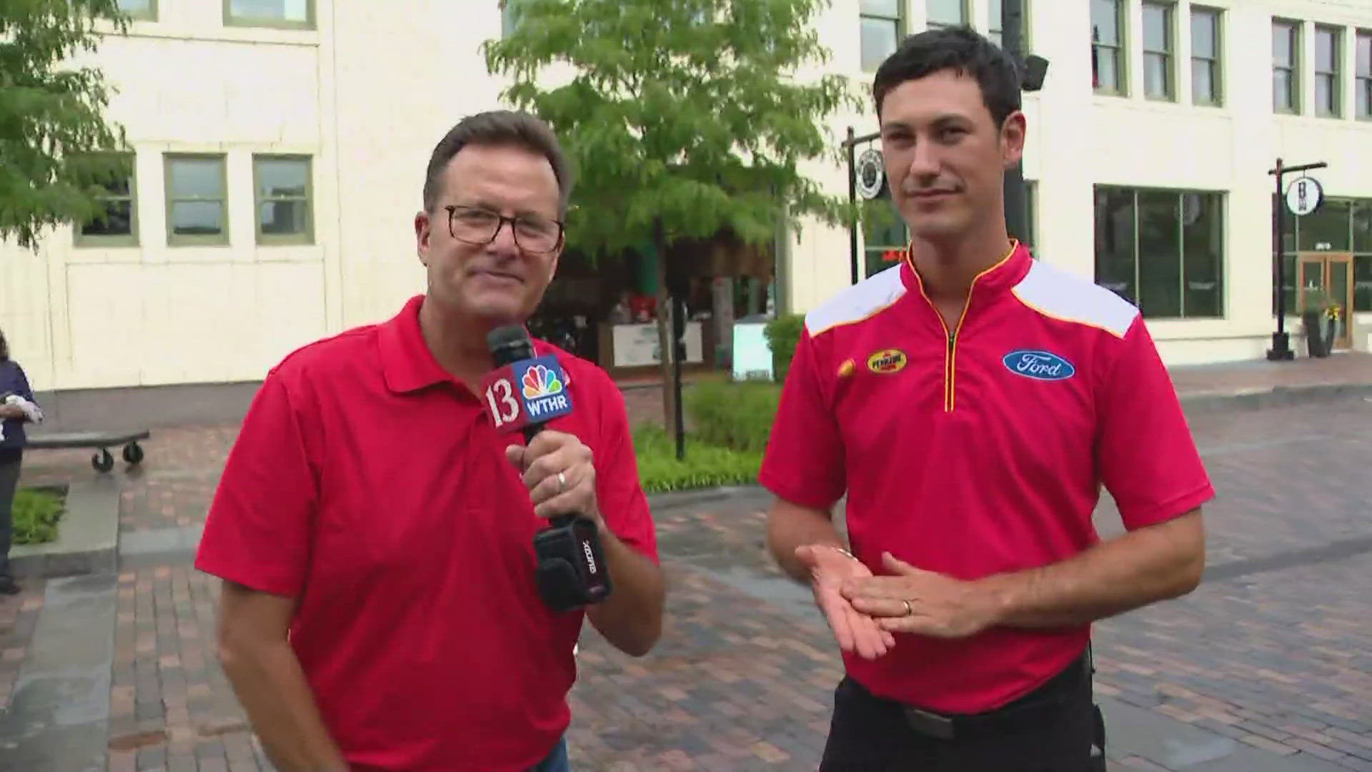 13Sports director Dave Calabro talks with Joey Logano during Brickyard Fan Fest.