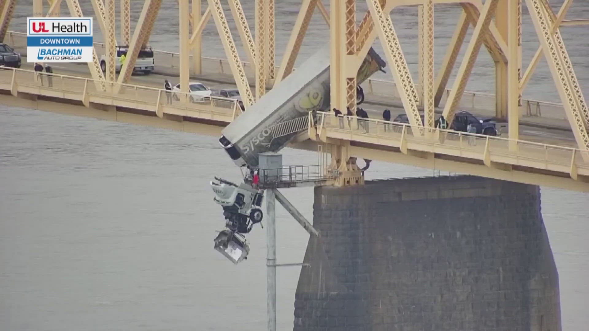 A semi driver is safe after she ended up dangling over the Ohio River on a bridge connecting southern Indiana and Louisville.