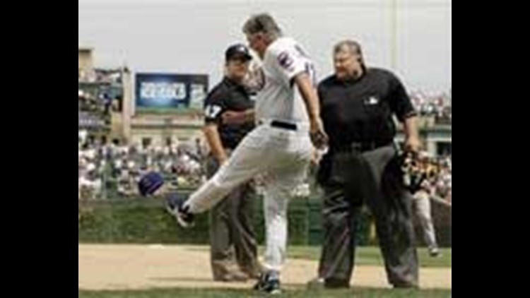 Chicago Cubs manager Lou Piniella tips his hat to the crowd before