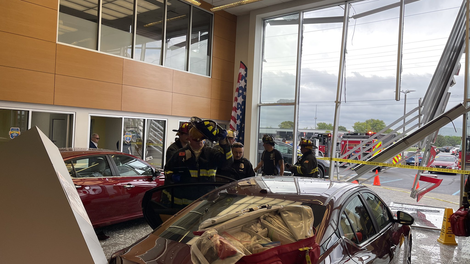 Two people were taken to the hospital after a car crashed into the Tom Wood Nissan dealership in Carmel.