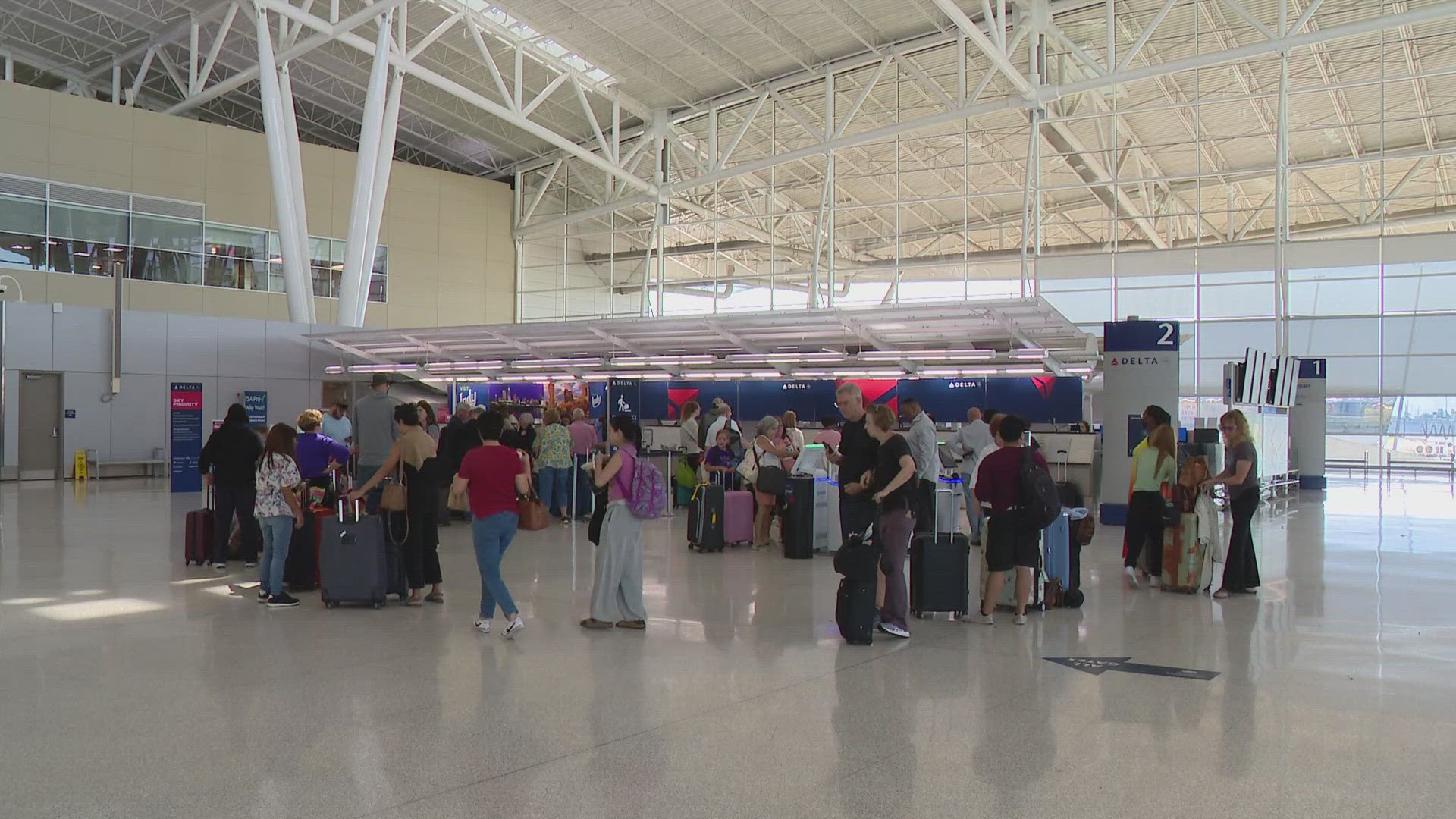 13News reporter Marina Silva talks with travelers at Indianapolis International Airport who say they are frustrated with flight delays and cancellations.