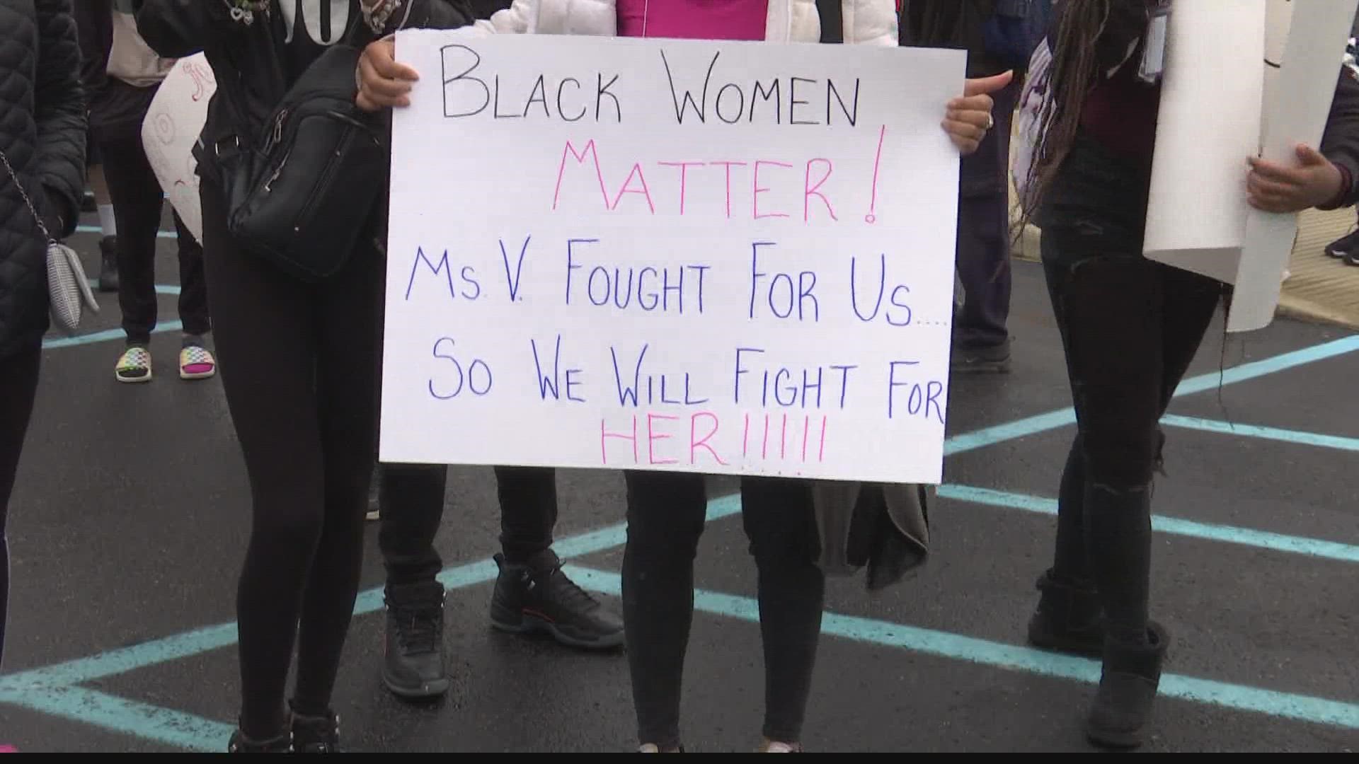 About 30 students left the building during lunch and held handmade poster signs in front of the school to protest a recent firing.