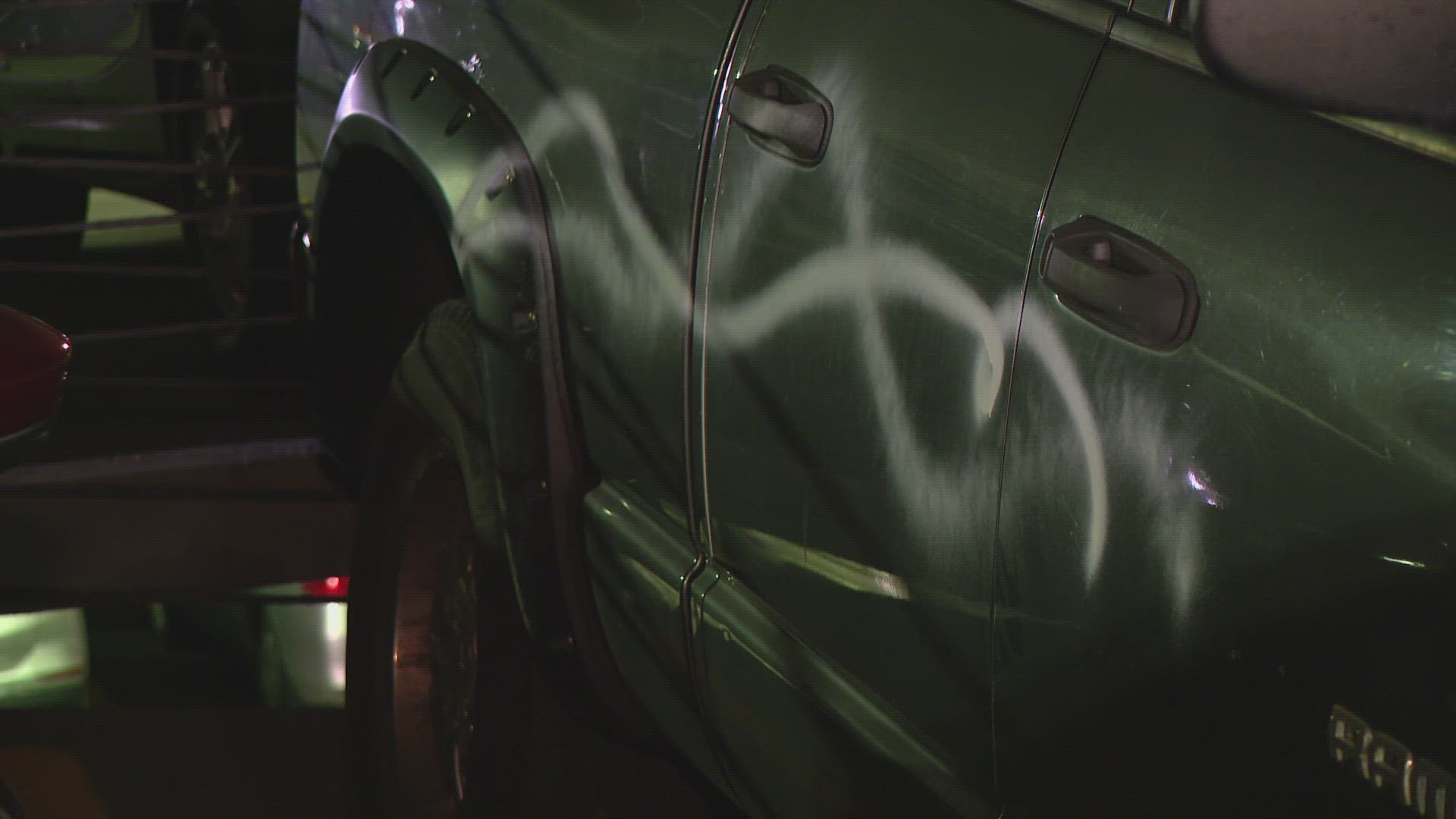 Dozens of cars were spray painted white while parked in a garage on Washington Street.