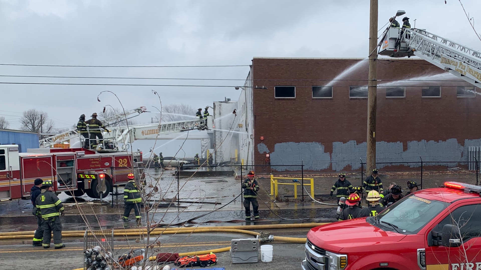 Two people, including an Indianapolis firefighter, were injured during an east side building fire Thursday.