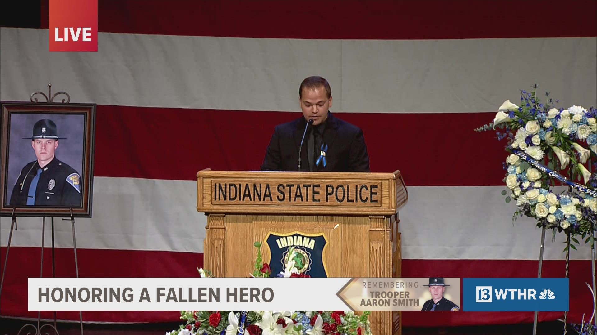 Pastor Christopher Marlin reads a letter from Tony Marlin, the uncle of fallen ISP Trooper Aaron Smith.