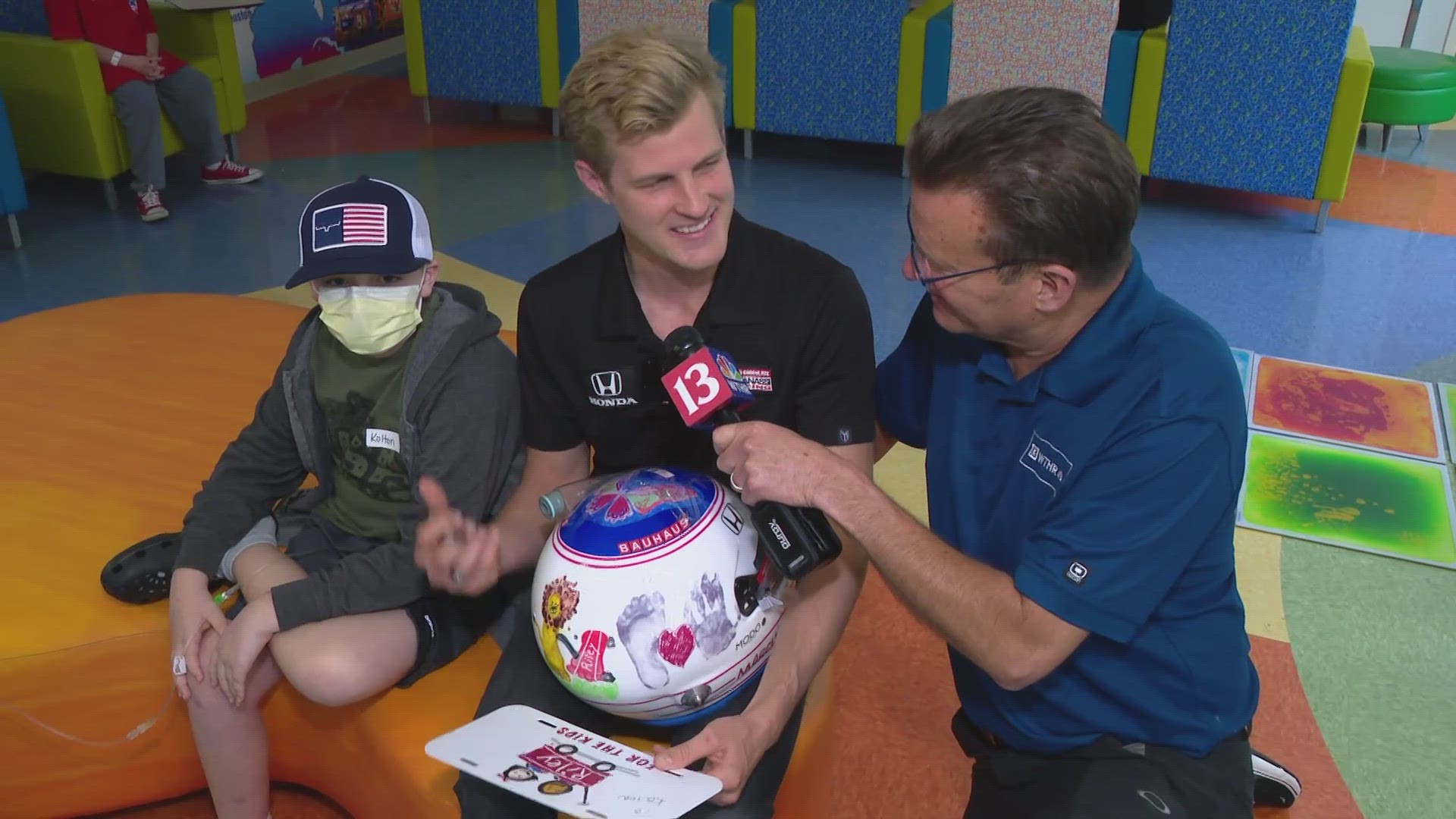 Ericson showed off a helmet that included artwork from Riley kids.