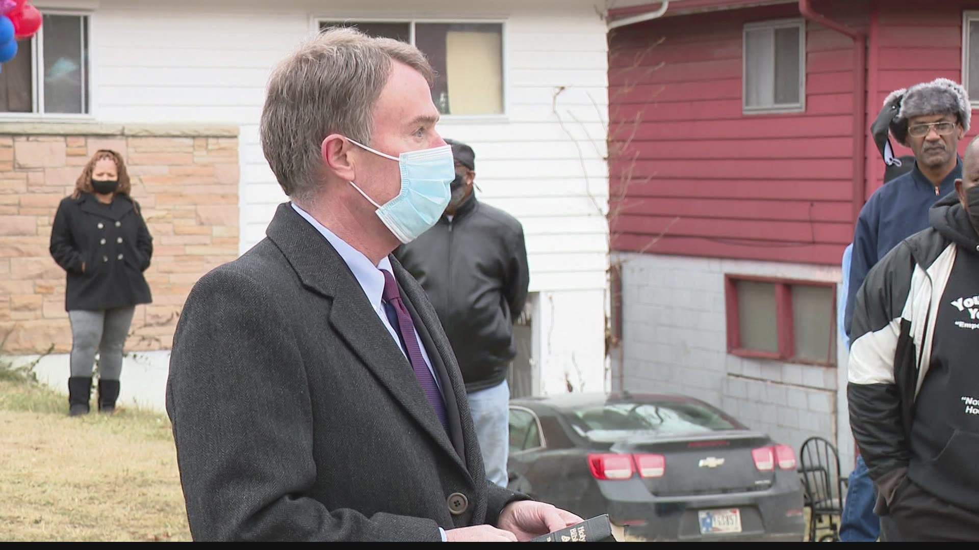 Family and friends gathered Saturday outside the home where six people were murdered last weekend.