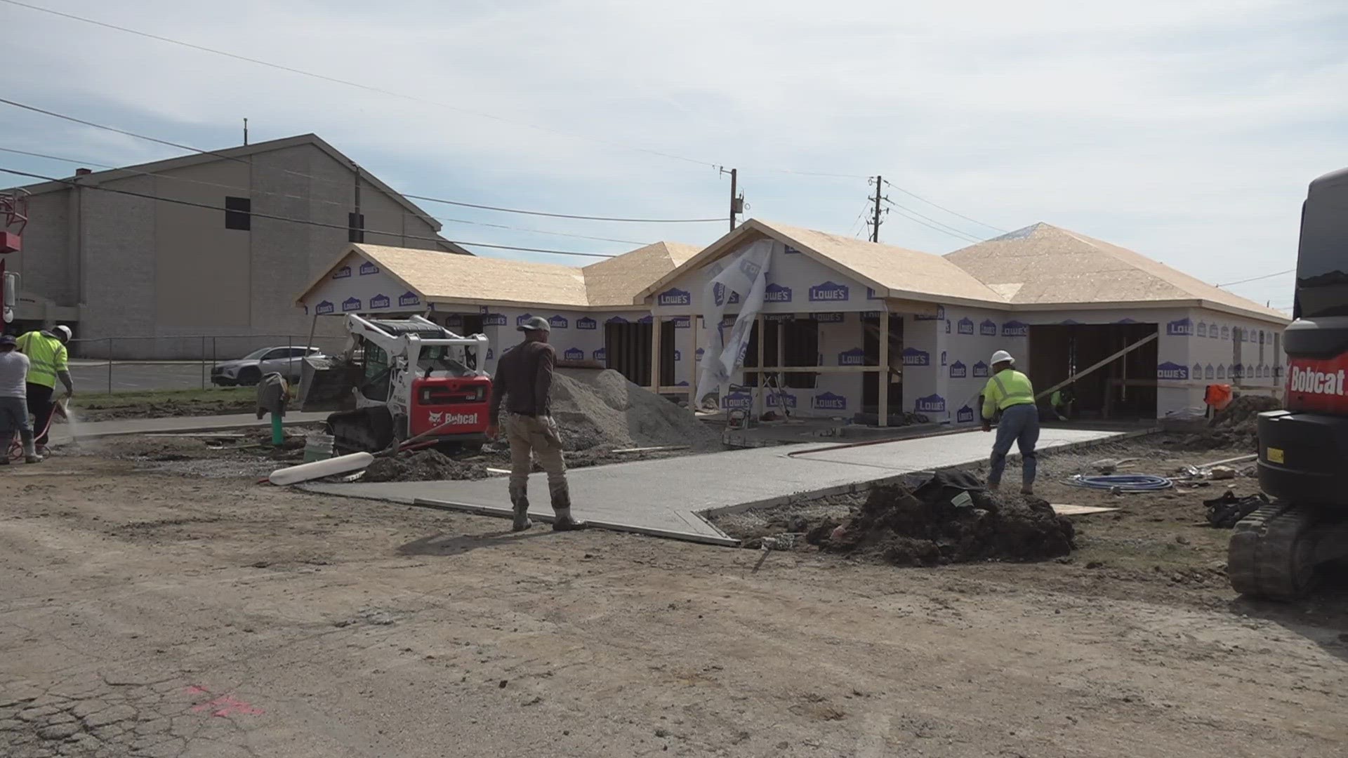 Two new houses are completed, and families have moved in. Five are under construction and there's plans for three more.