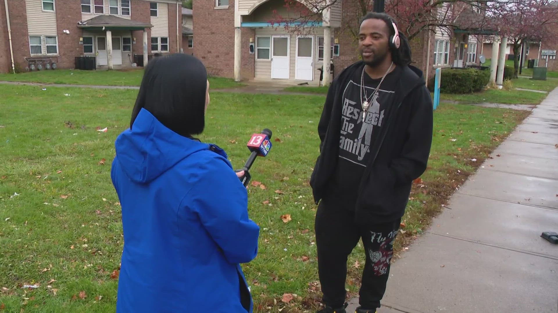 13News reporter Anna Chalker talks with neighbors in the neighborhood near 30th and Emerson after a teen was killed and another injured in a shooting.