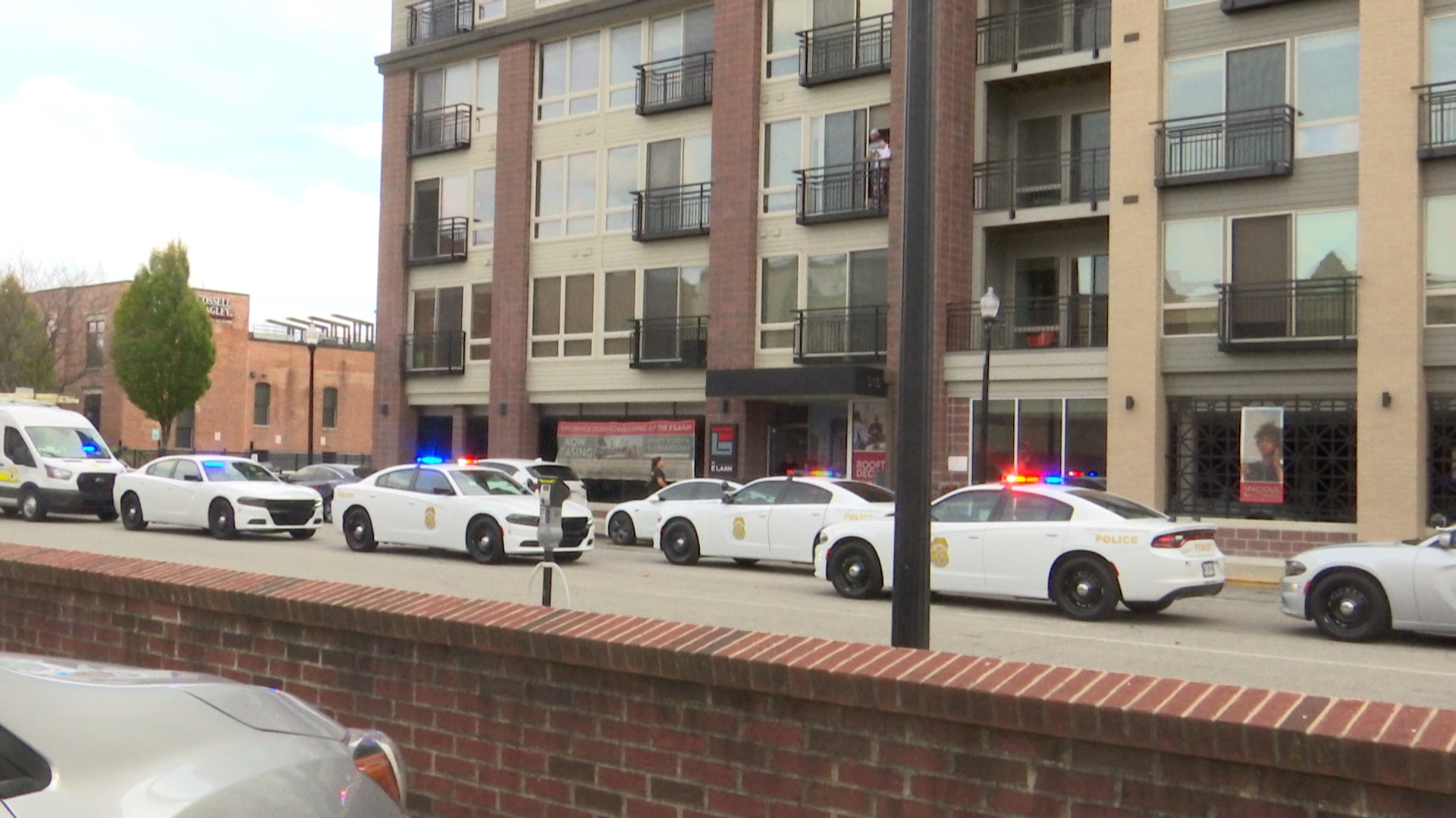 Tenants at the E'Laan Apartments in downtown Indianapolis watched from their balconies Sunday afternoon as IMPD cars flooded the street to respond to a shooting.