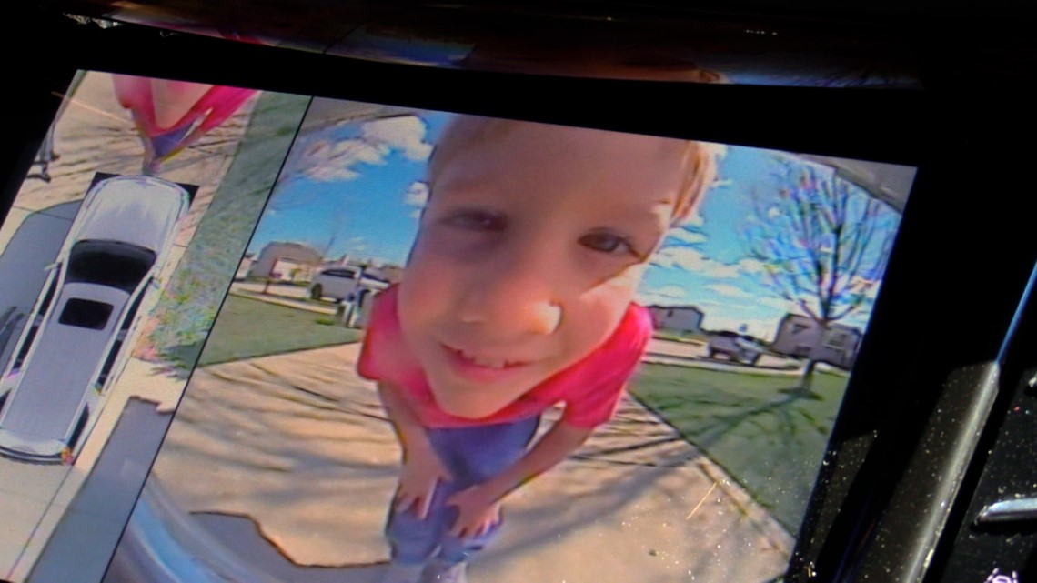 child in a rear view camera on car 