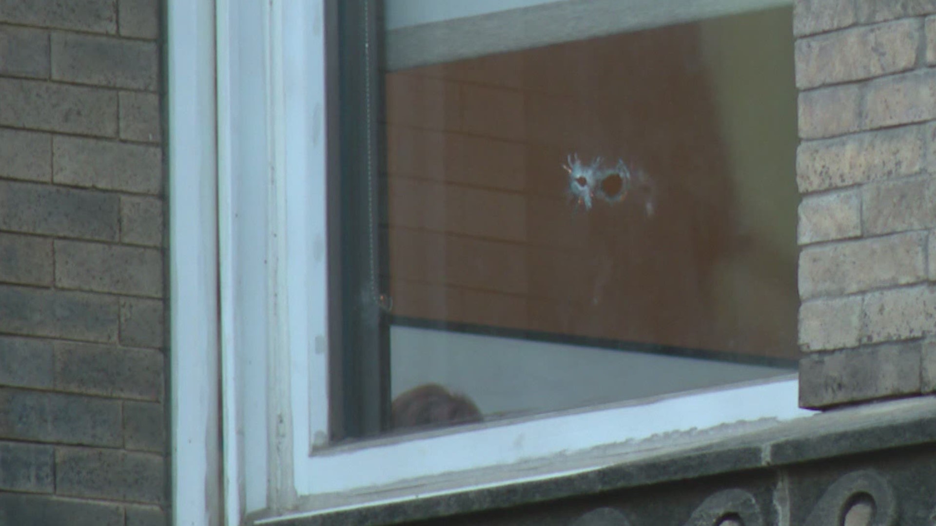 Bullets from an overnight gunfight damaged cars and buildings near Georgia and Meridian Street.