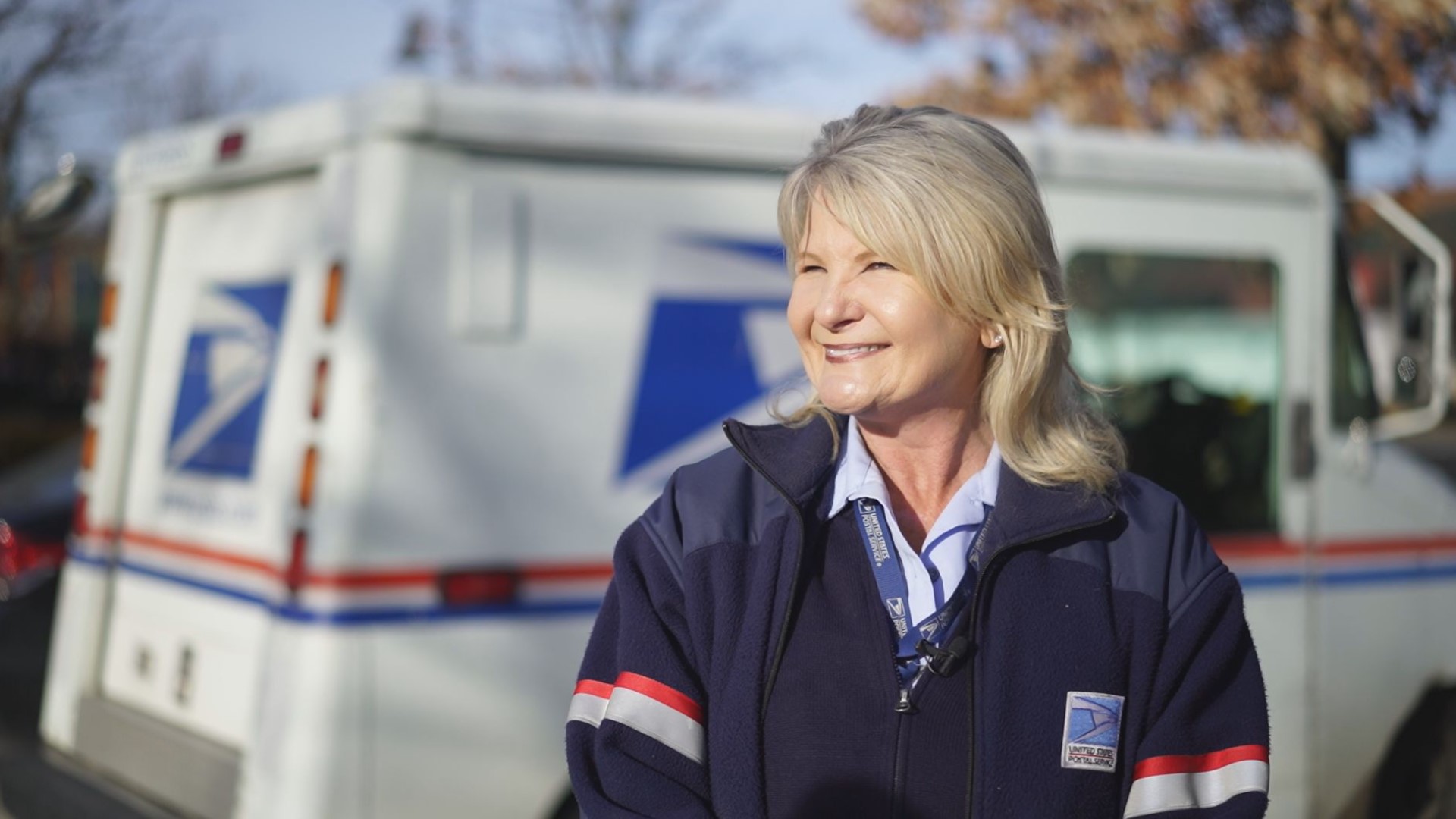 Holli Wood is a U.S. Postal Service letter carrier who uses lip reading and sign language to communicate with customers.