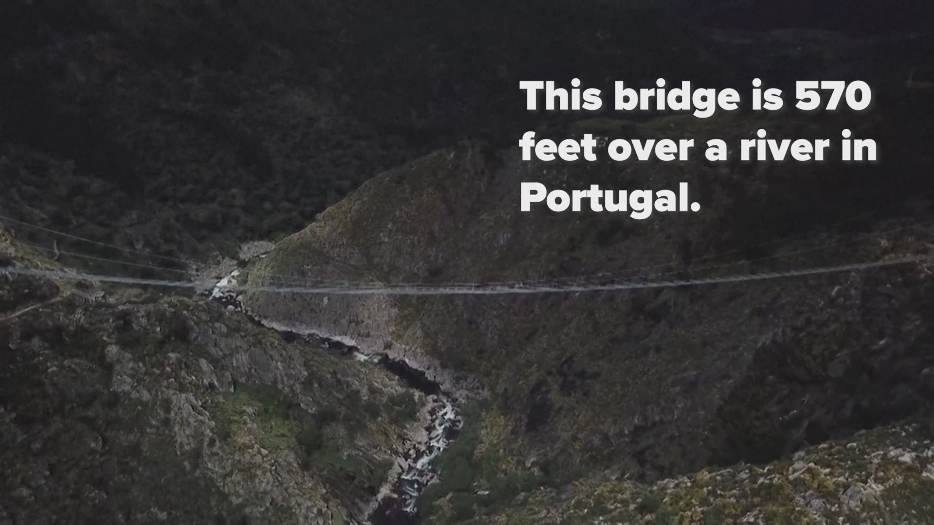 The Arouca Bridge stretches nearly one-third of a mile across a gorge over the Paiva River as it flows through a waterfall.