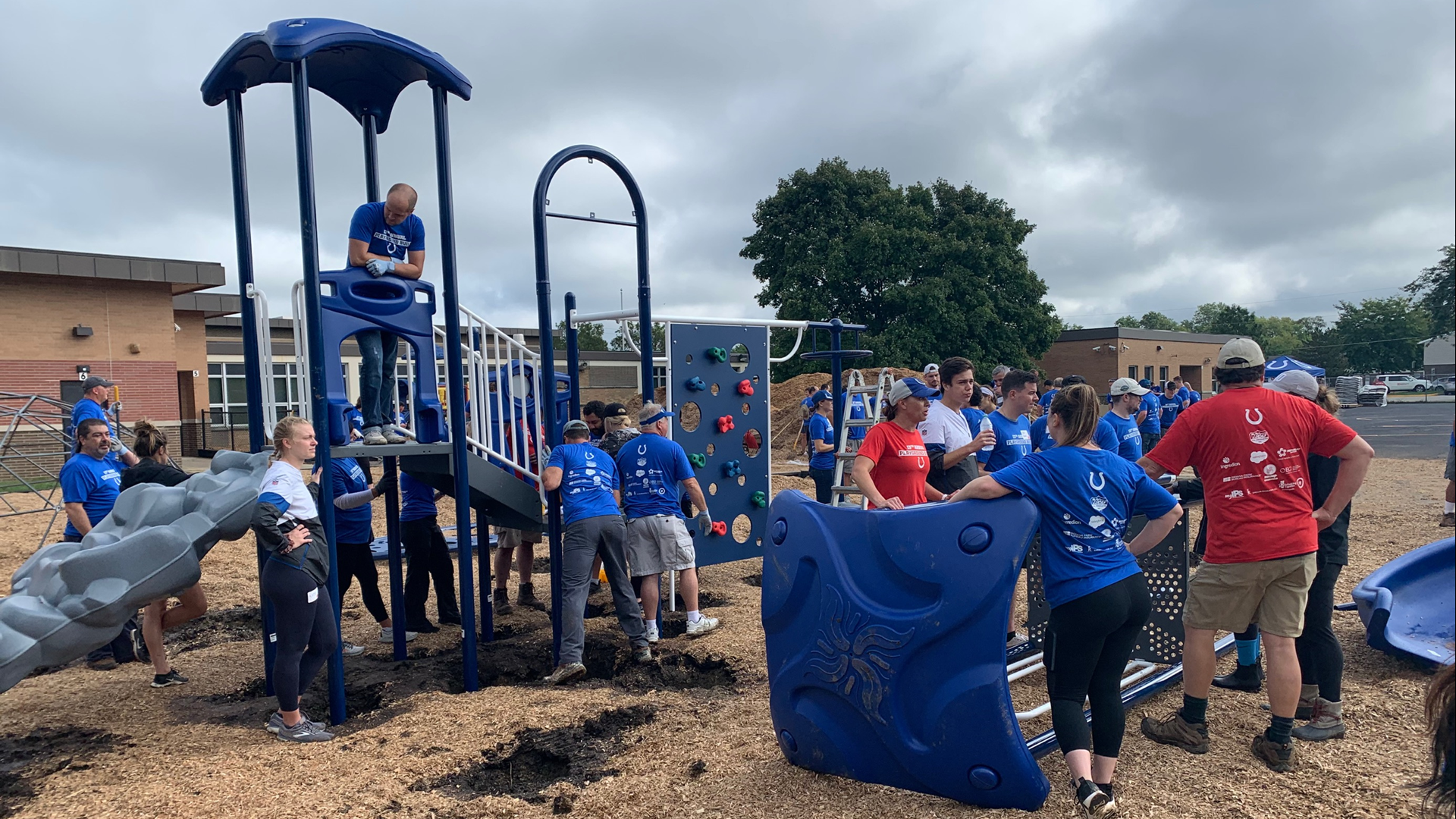 Players and volunteers with the Colts organization helped build a new playground and outdoor classroom at IPS School #99 on their day off.