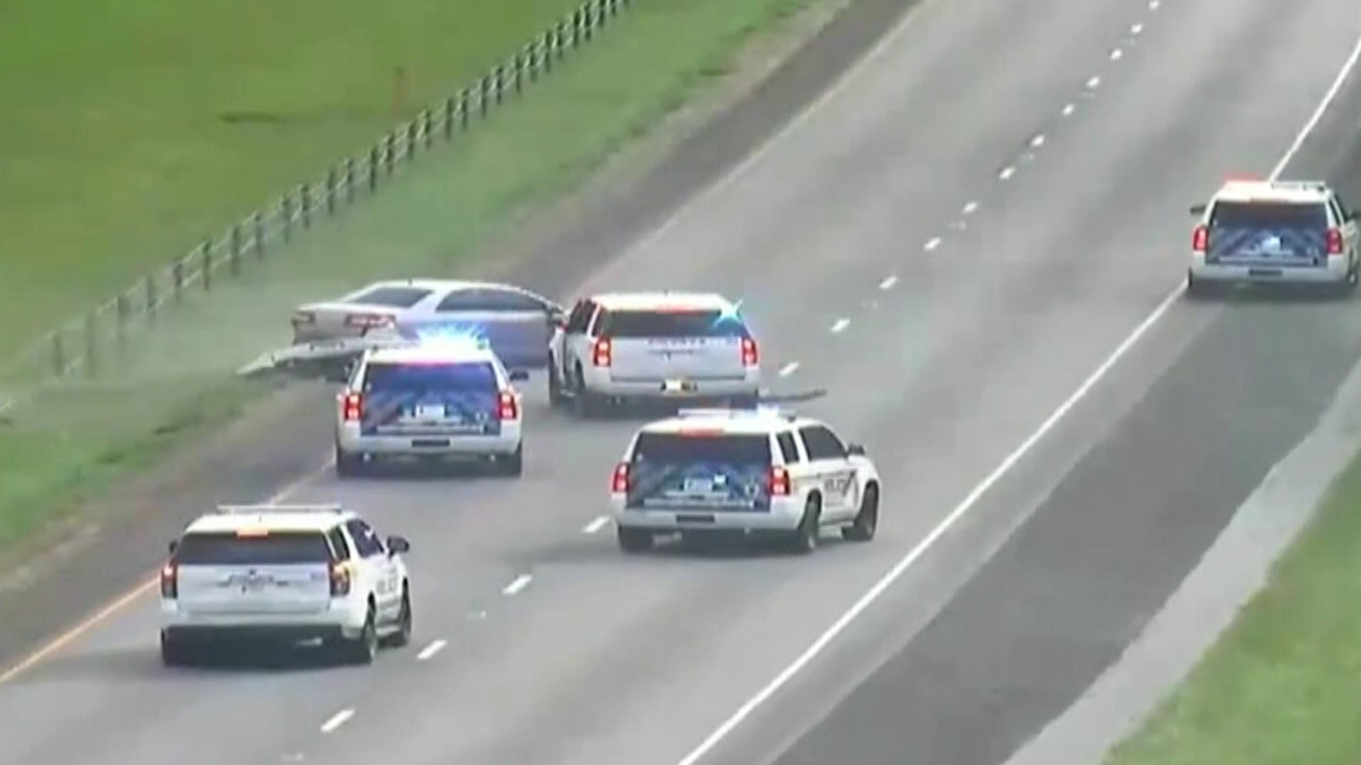 An officer fired shots at the stolen car after it nearly hit him. (Video courtesy: INDOT)