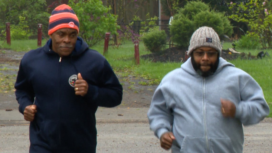 Visuallyimpaired runner & guide running in Indy Mini