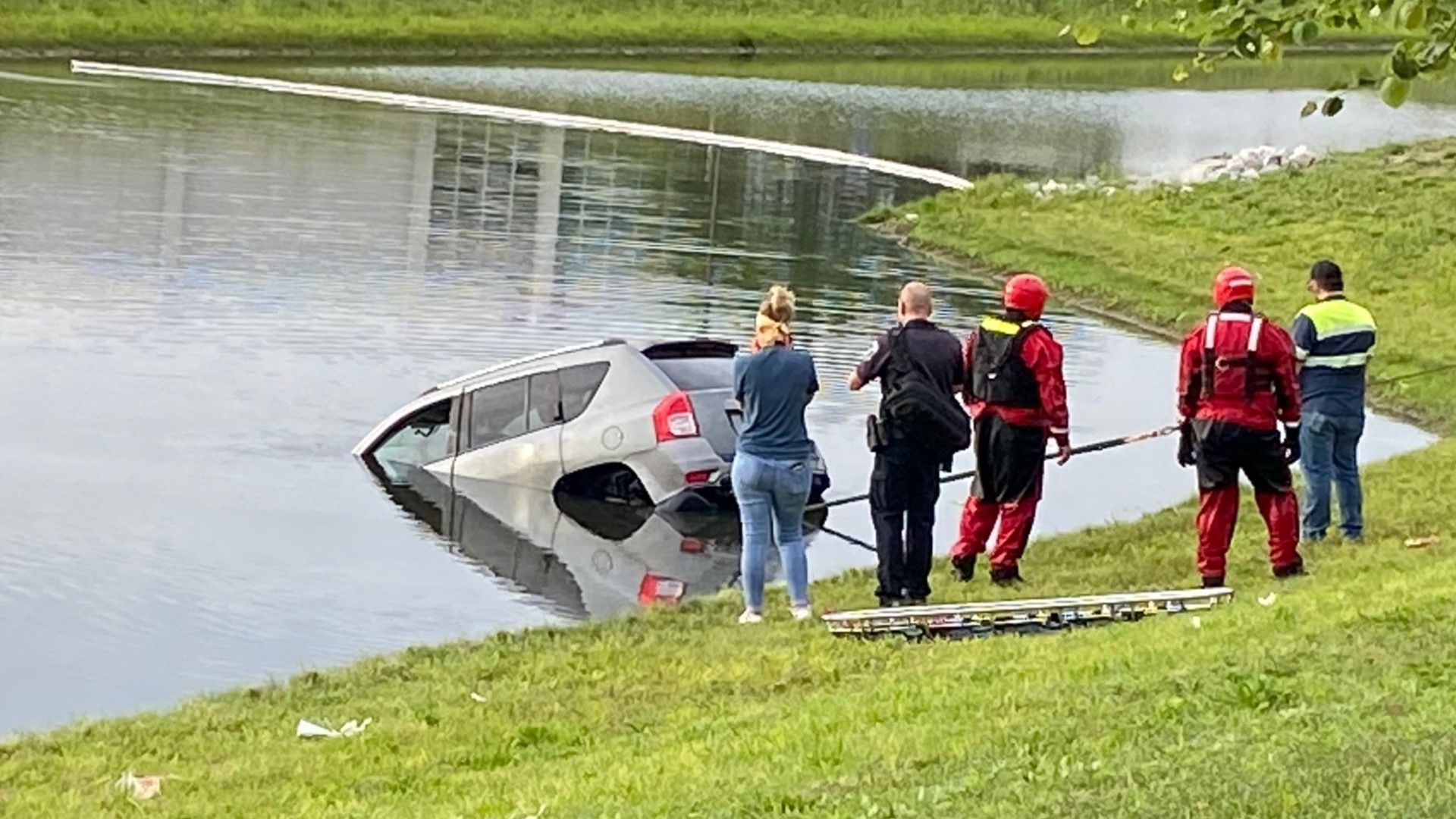 Four people were inside but only two were able to escape before the Jeep sank.